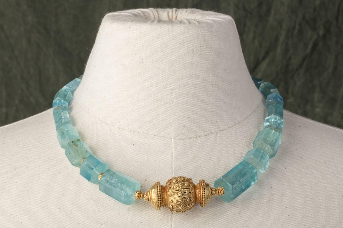 Outstanding beveled aquamarine beads with great clarity strung with 22K gold beads between and lovely, old Indian 22K gold bead at the center.  All the gold pieces have fine granulation work.   Carat weight of aquamarines is 677.  The necklace has a