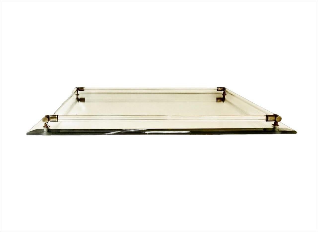 Beveled edge mirror tray, with glass rails finished with metal corners. The tray has four plastic feet. Measuring length 40.7 cm / 16 inches by width 30.5 / 12 inches , and height 2.3 cm / .9 inches including the rails. The tray is in very good