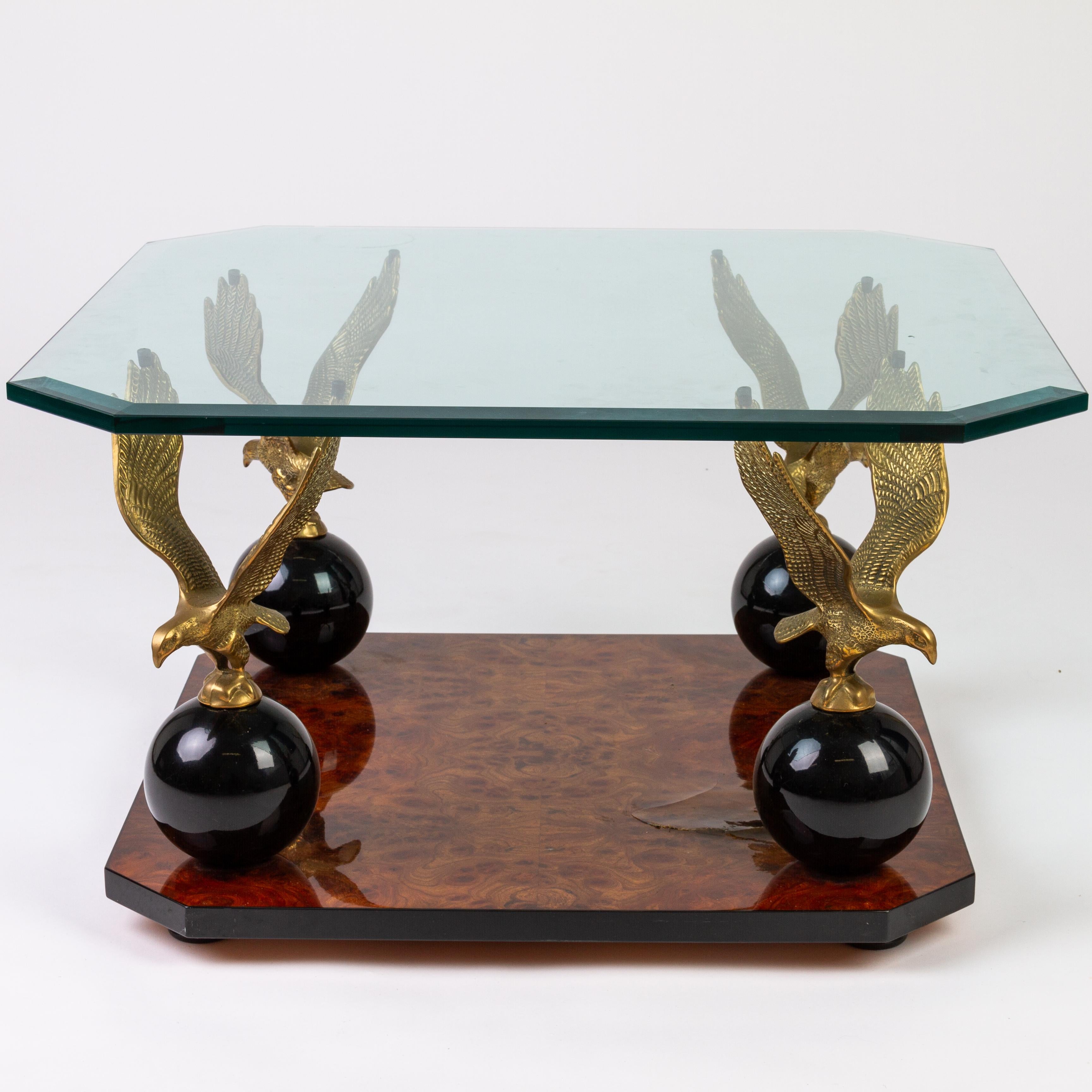 A stunning and elegant Beveled Glass Burr Walnut Eagles Coffee Table
With glass top and brass eagle sculptures resting on black spheres
There is a crack in one corner of the table on the burr walnut surface, but this doesn't detract much from the