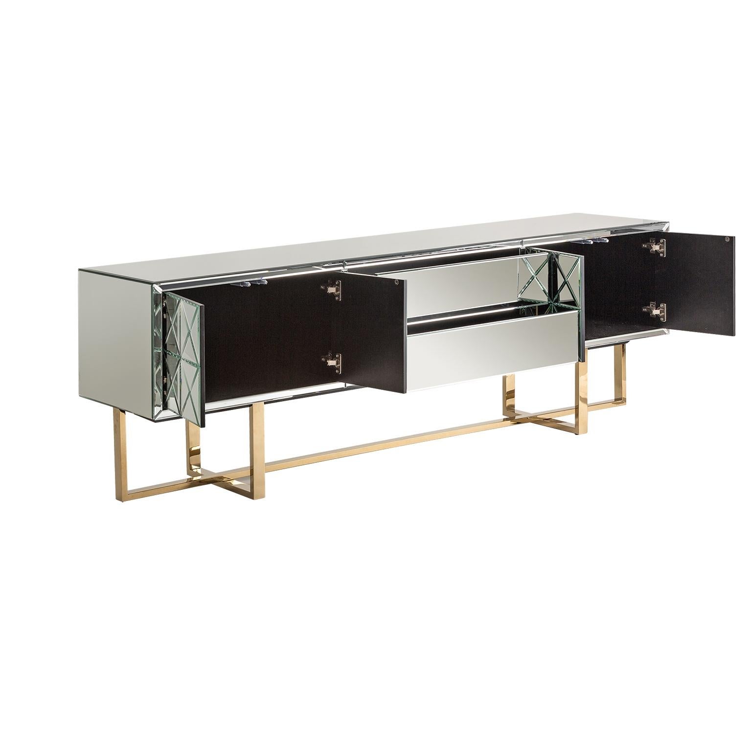 Sparkling and sophisticated mirrored sideboard with aerial gold metal feet four mirrored doors that and 2 central drawers.