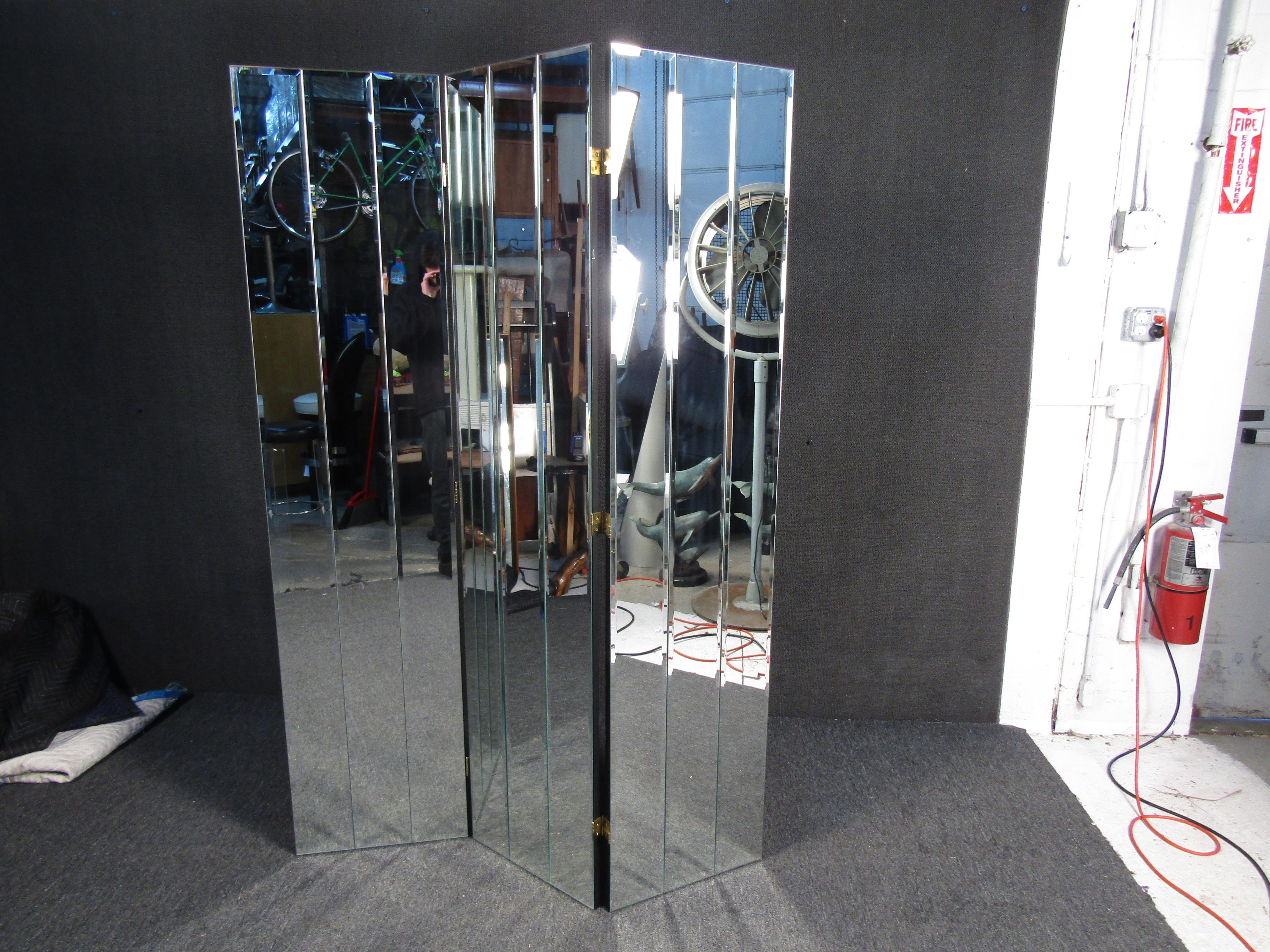 This elegant vintage mirrored room divider features four panels with bevelled, mirrored glass. Versatile piece that conveniently folds for storage. Lovely addition to any home, business, or office. Please confirm item location (NY or NJ).