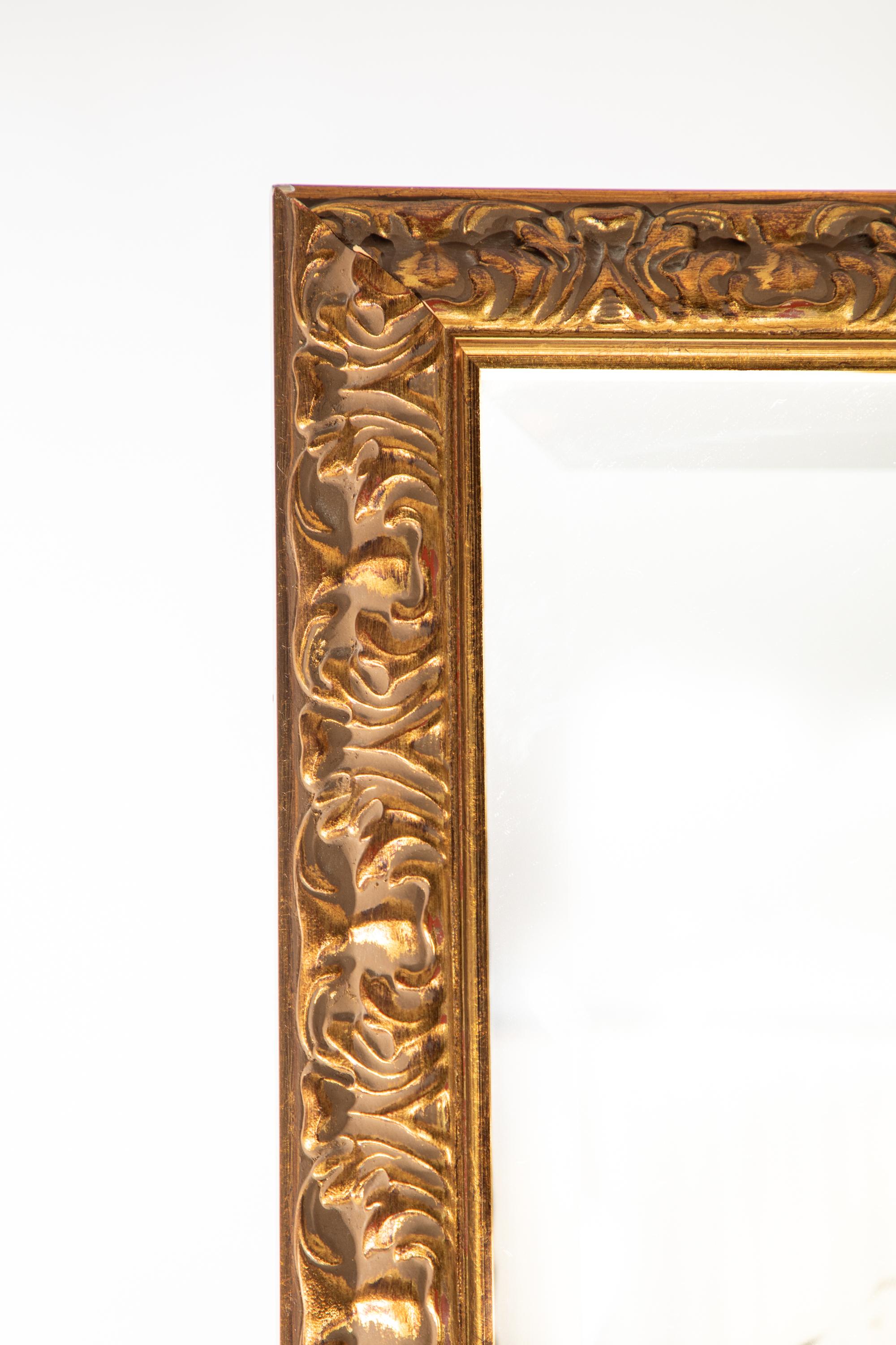 Beveled mirror in gilt frame.  Rectangle 
