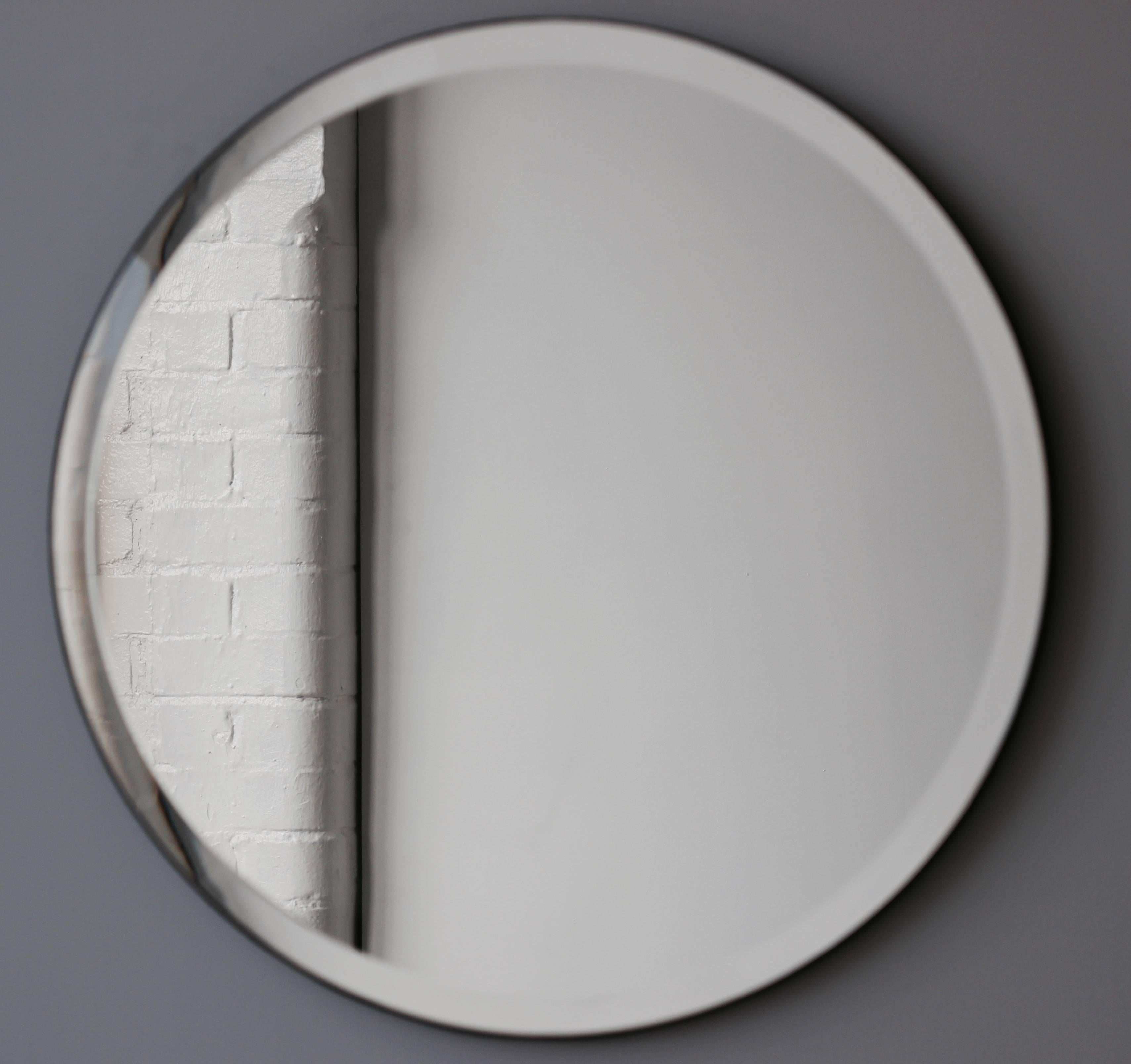 Art Deco style Orbis™ frameless mirror with an elegant bevel, velvet backing and optional brass clips. Designed and handcrafted in London, UK.

Our mirrors are designed with an integrated French cleat (split batten) system that ensures the mirror is