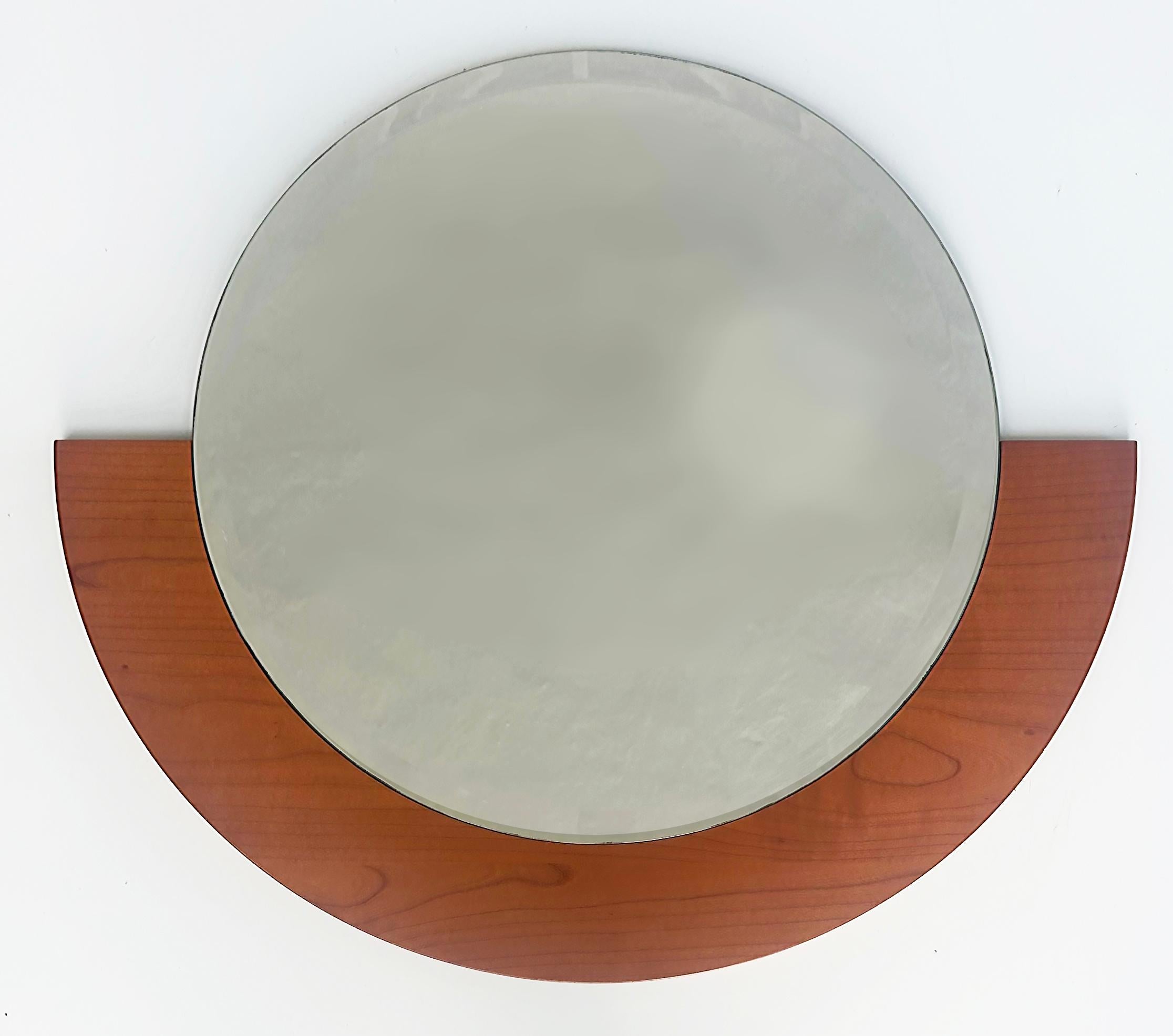 Beveled Wall Mirror with Wood Frame

Offered for sale is a beveled wall mirror with a blonde wood frame. The round beveled mirror rests upon the half-circle lower framed.