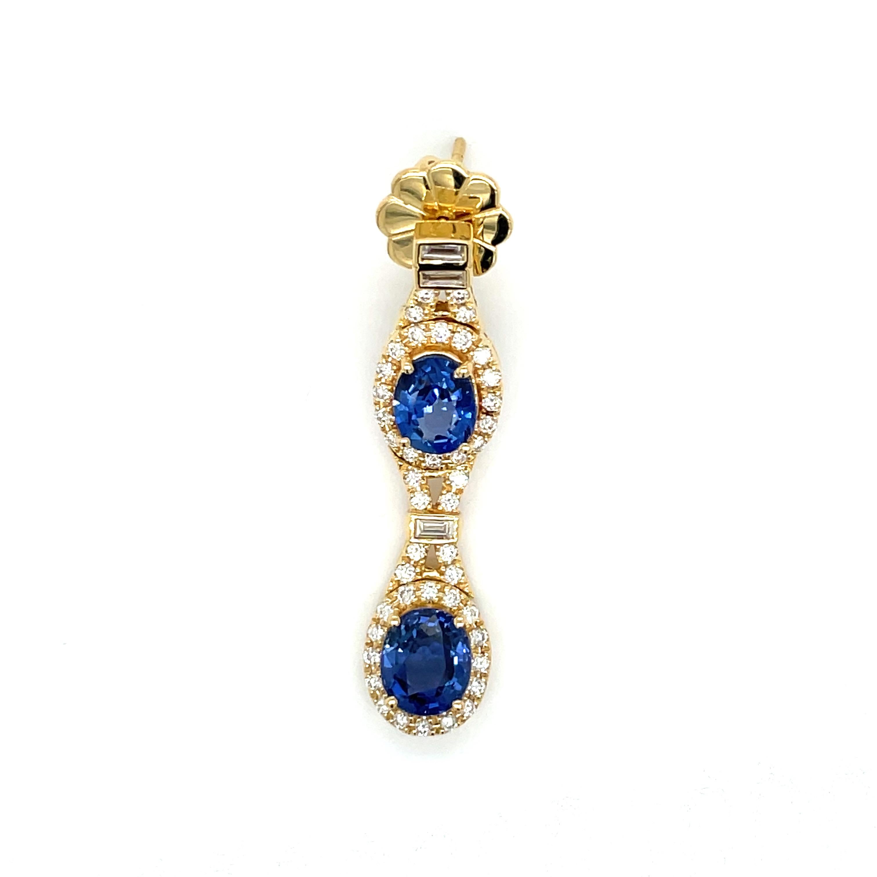 You'll be the center of attention with these vibrant sapphire and diamond Beverley K dangle earrings. Featuring four oval shaped sapphires weighing 5.60 carats, and 2.37 carats of round and baguette shaped diamonds, with SI1 clarity. The stones are