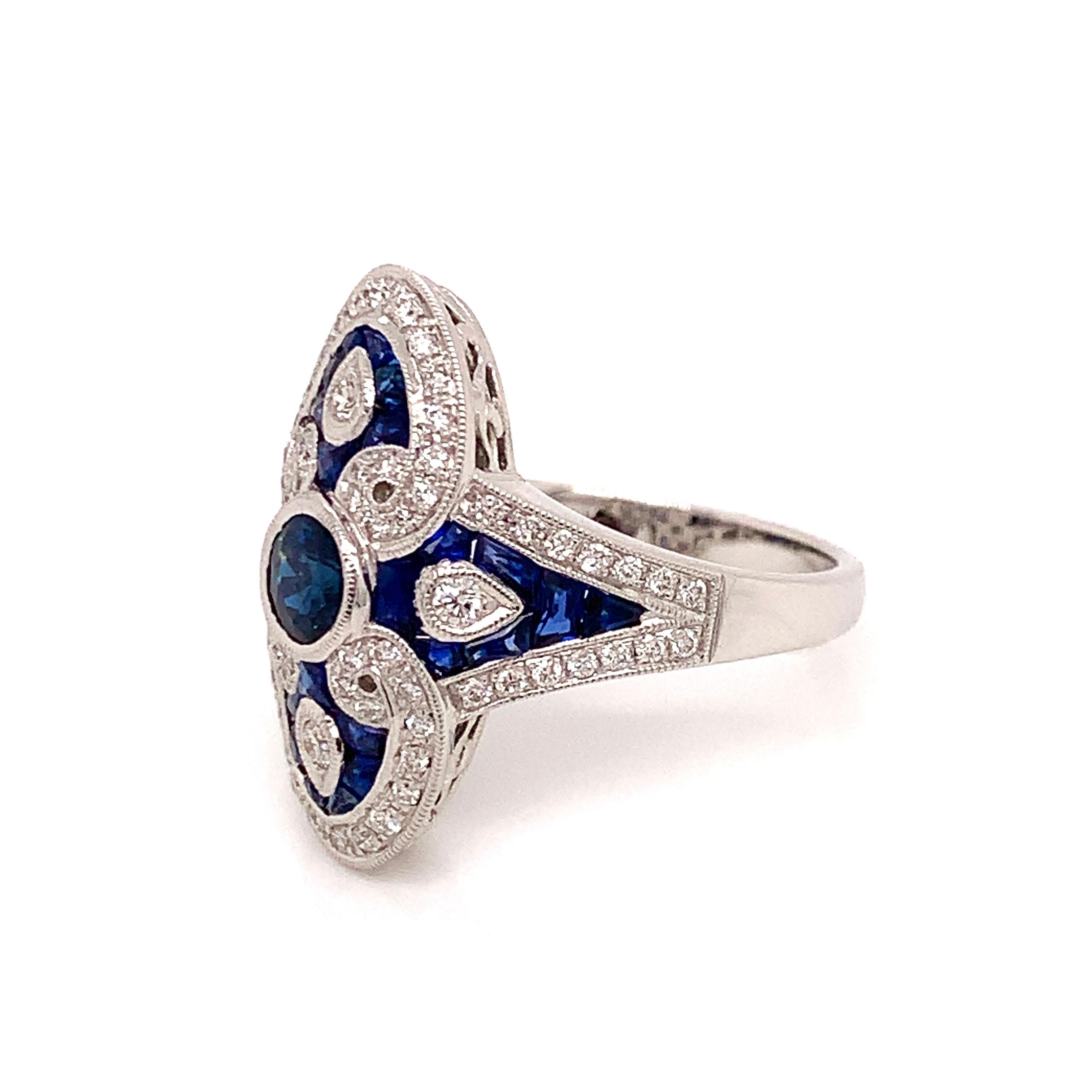 This vintage inspired ring by designer Beverley K is beautifully designed.  Its elongated shape is flattering on any hand.  A .66 carat round sapphire is surrounded by .47 cttw round diamonds and 1.00 cttw in french cut sapphires.  

This is a brand