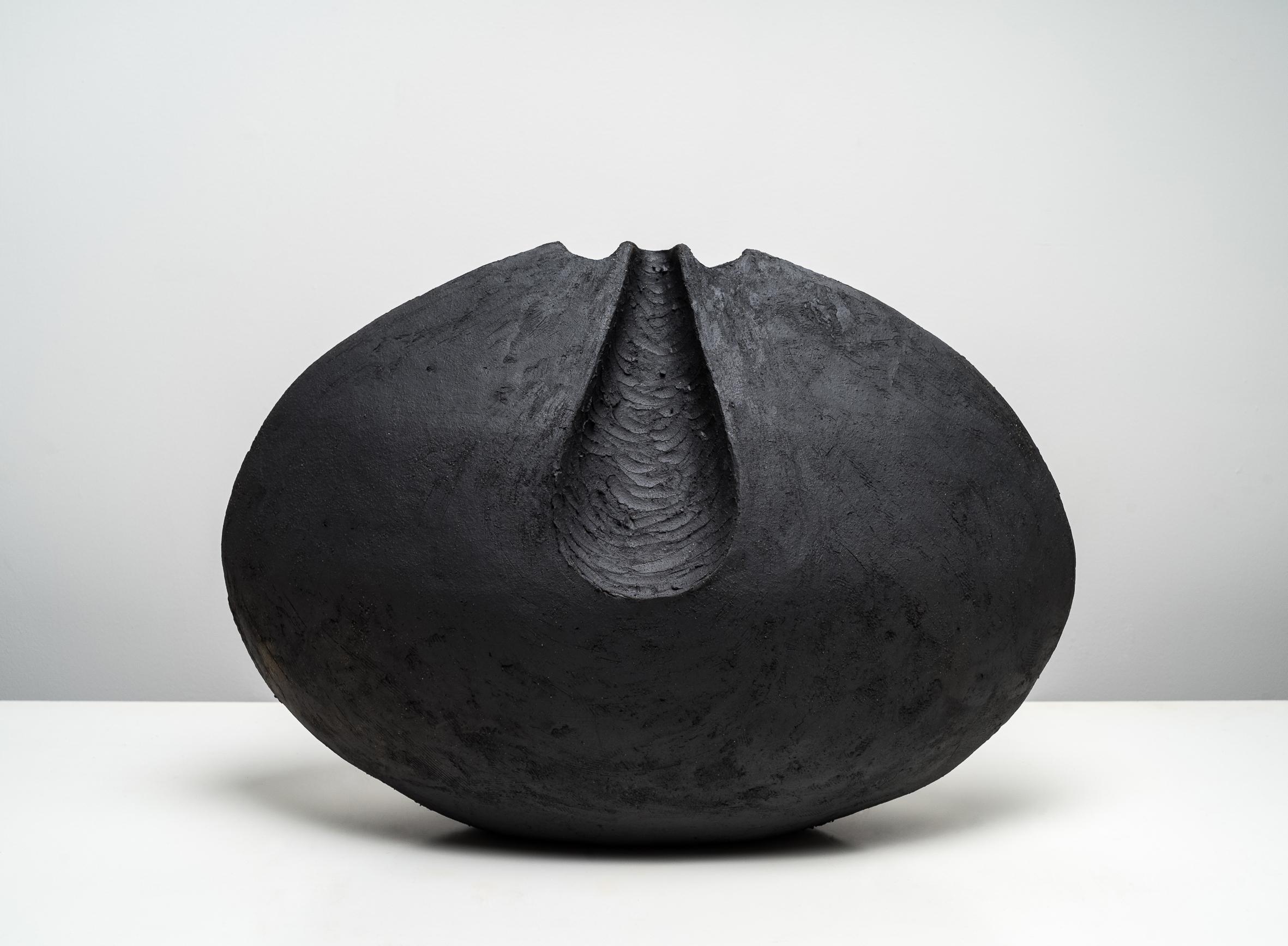 Artist Commentary:
Black stoneware; cone 5/6 oxidation firing

"Inspired by my nieces voluptuous pregnant belly "

Keywords: vessel, ceramic, classic, minimal, clay, black, classical, minimal, round

Artist Biography: 
Beverly Morrison (Los Angeles,
