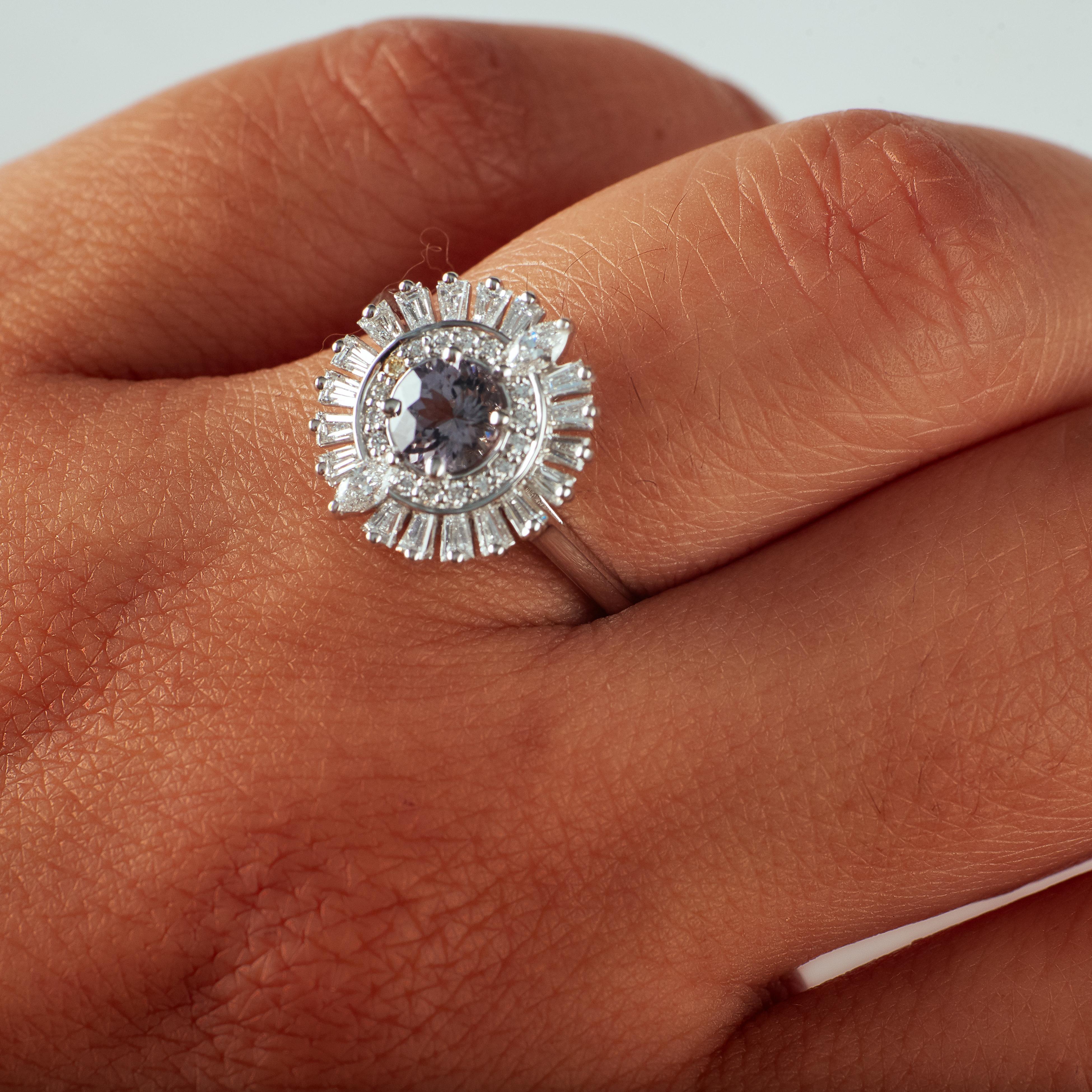 The name says it all! This gasp-worthy 14k white gold ring features an incredible grey spinel center stone accentuated by a .75ctw diamond halo. Perfect for the bride who loves a hint of vintage glamour

Materials + Dimensions: 14k white gold,