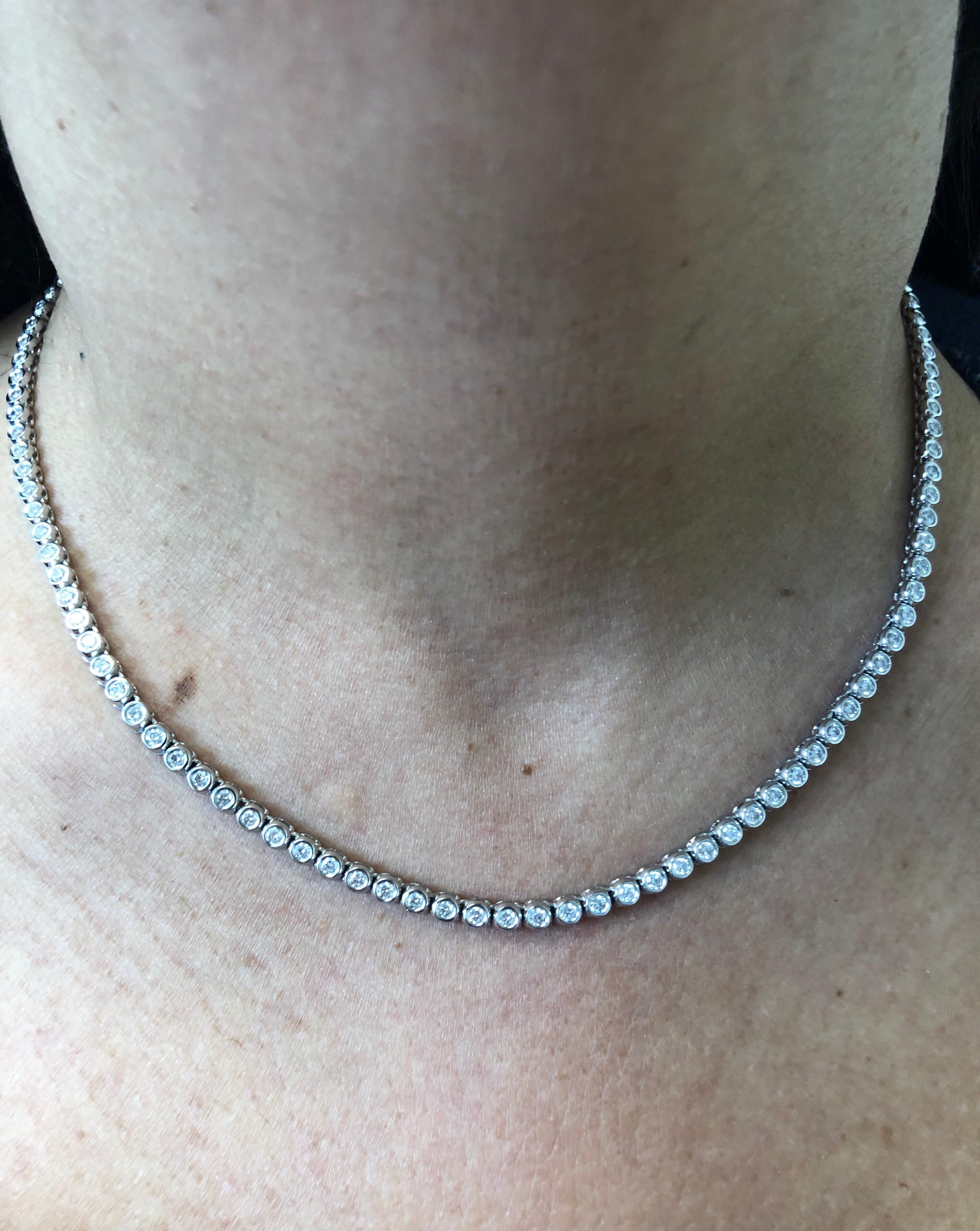 Bezel set diamond necklace 17 inch set with 5 points of diamonds each stone. The diamond necklace is set in 14K white gold. The total weight of the necklace is 5.09 carats. The stones are G-H color, the clarity is SI1.