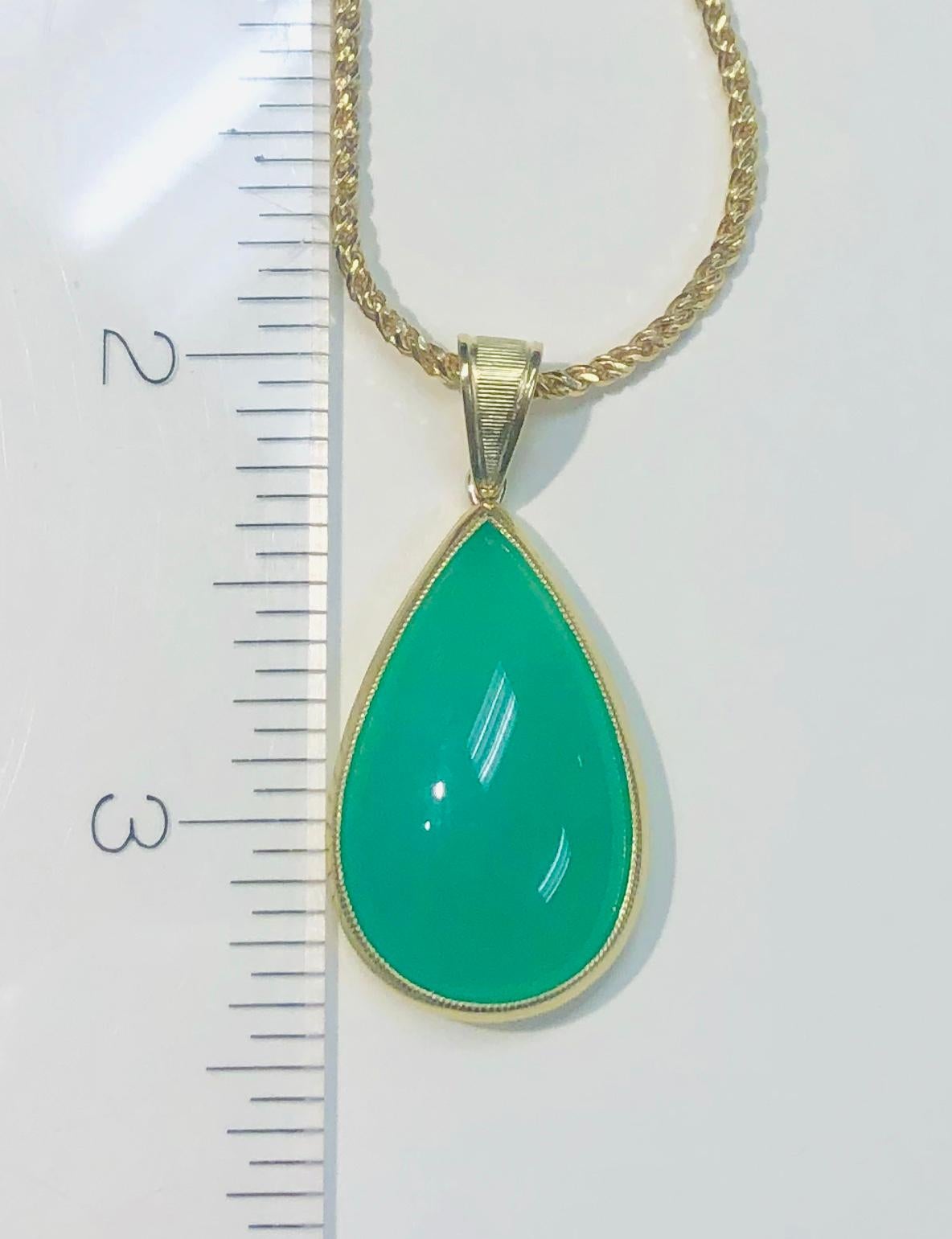 This beautiful pendant features an alluring 19.49 carat pear shaped chrysoprase cabochon of absolutely exquisite color! Chrysoprase is a lovely variety of quartz chalcedony, characterized by its distinctive green hue and gorgeous appearance. Set in