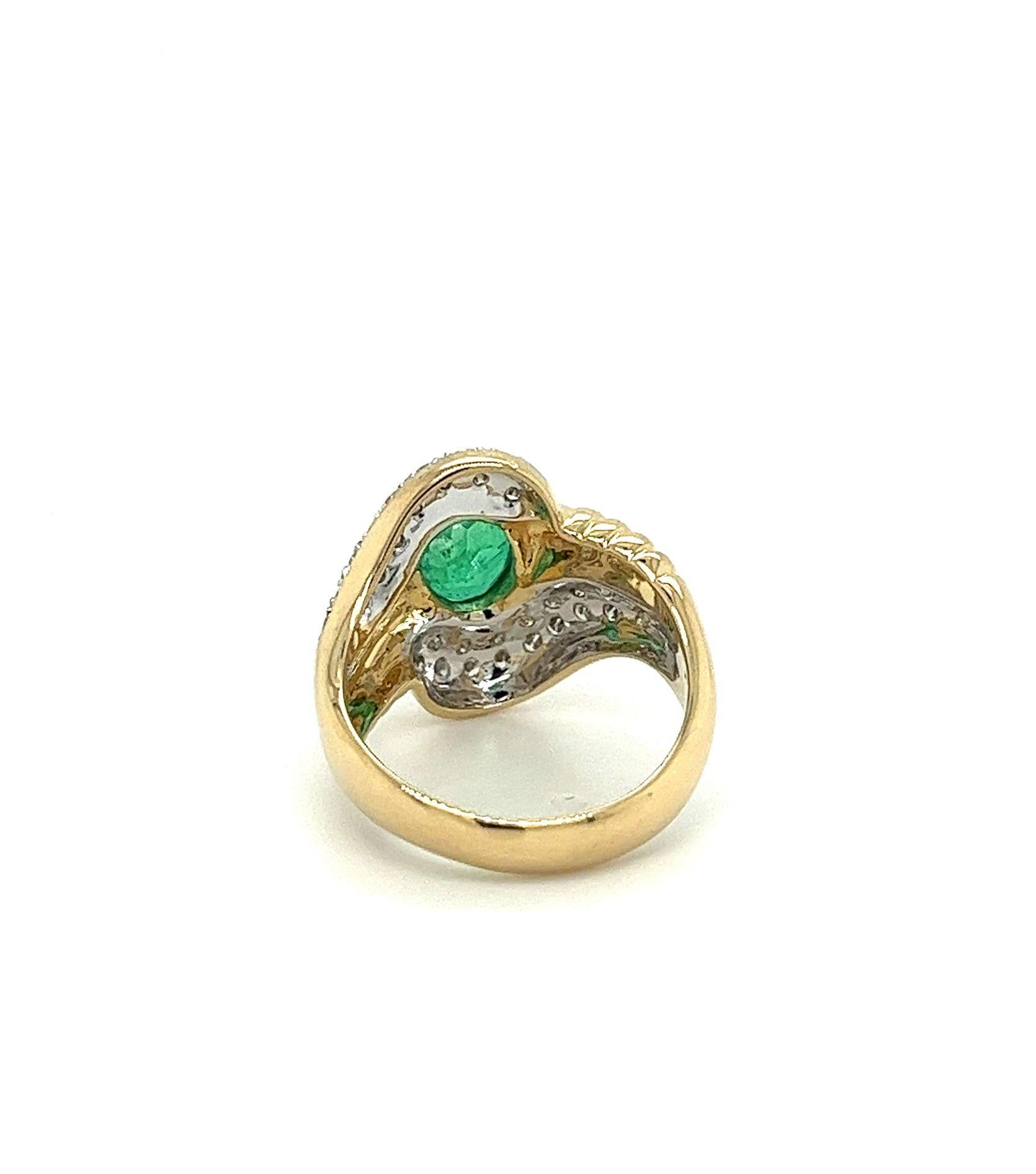 Natural emerald and diamond ring, featuring a magnificent 2.80-carat oval cut emerald, accompanied by 0.38 CTTW round cut diamond side stones, all beautifully set in a wavy textured 18K yellow gold motif. Set with an open back that allows for the