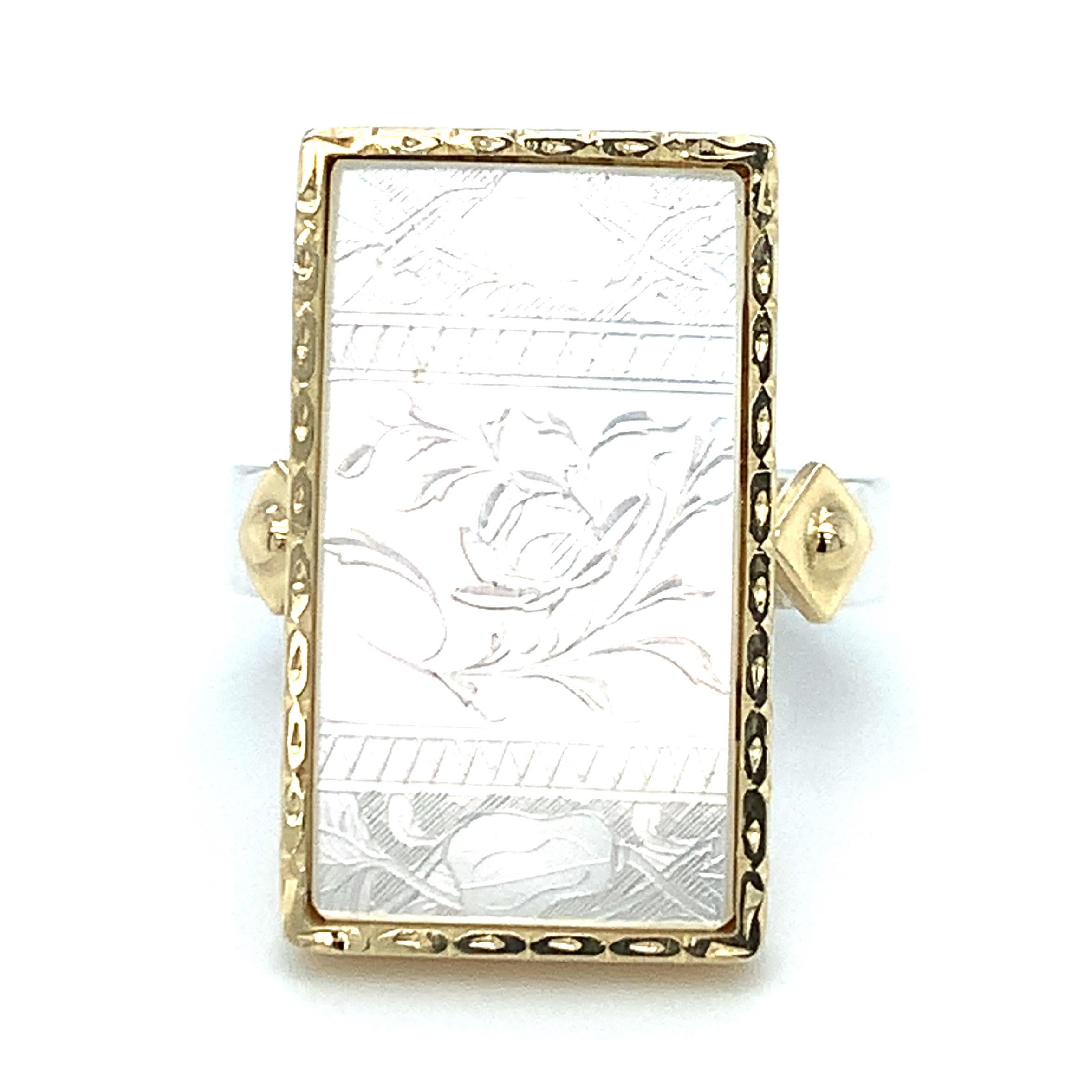 This ring features an antique, mother-of-pearl Chinese gambling counter with motifs dating back to the 18th century. Counters such as this were originally carved in China for export to Britain, where the British would use them much like we use poker