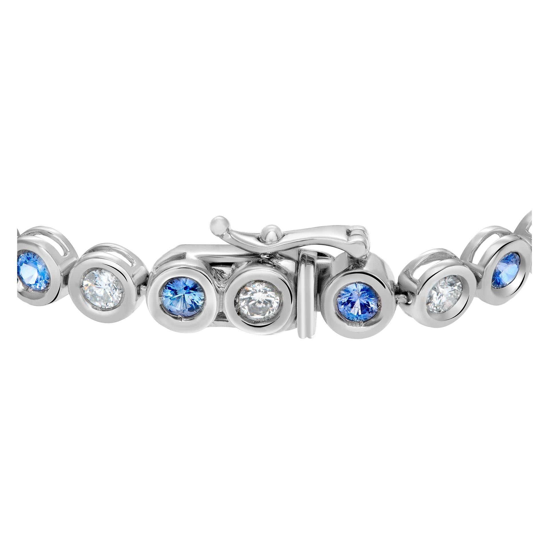 Bezel set blue sapphire and diamond line bracelet in 18k white gold; Approximately 1.48 carats in G-H color, VS-SI clarity round dimonds and approximately 1.62 carats in round cut sapphires.  Width: 5mm (0.19