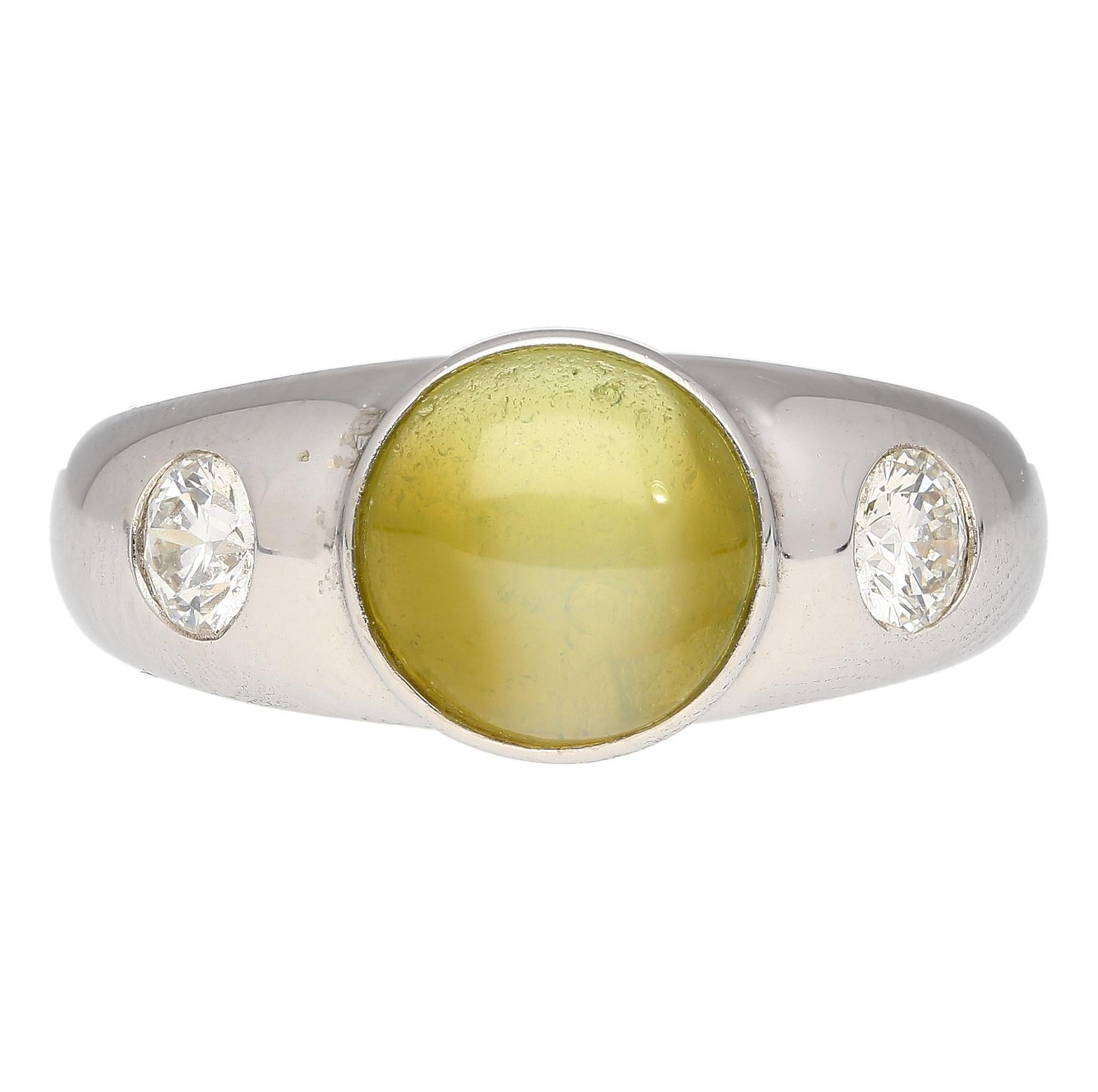 Bezel Set Chrysoberyl Cat's Eye and Diamond Three Stone Ring in 18K White Gold. Featuring a smooth polished finish and nicely centered cats eye. The center stone has excellent luster, uniformity and color.  

Details: 
Item Type: Ring 
 Metal: 18k