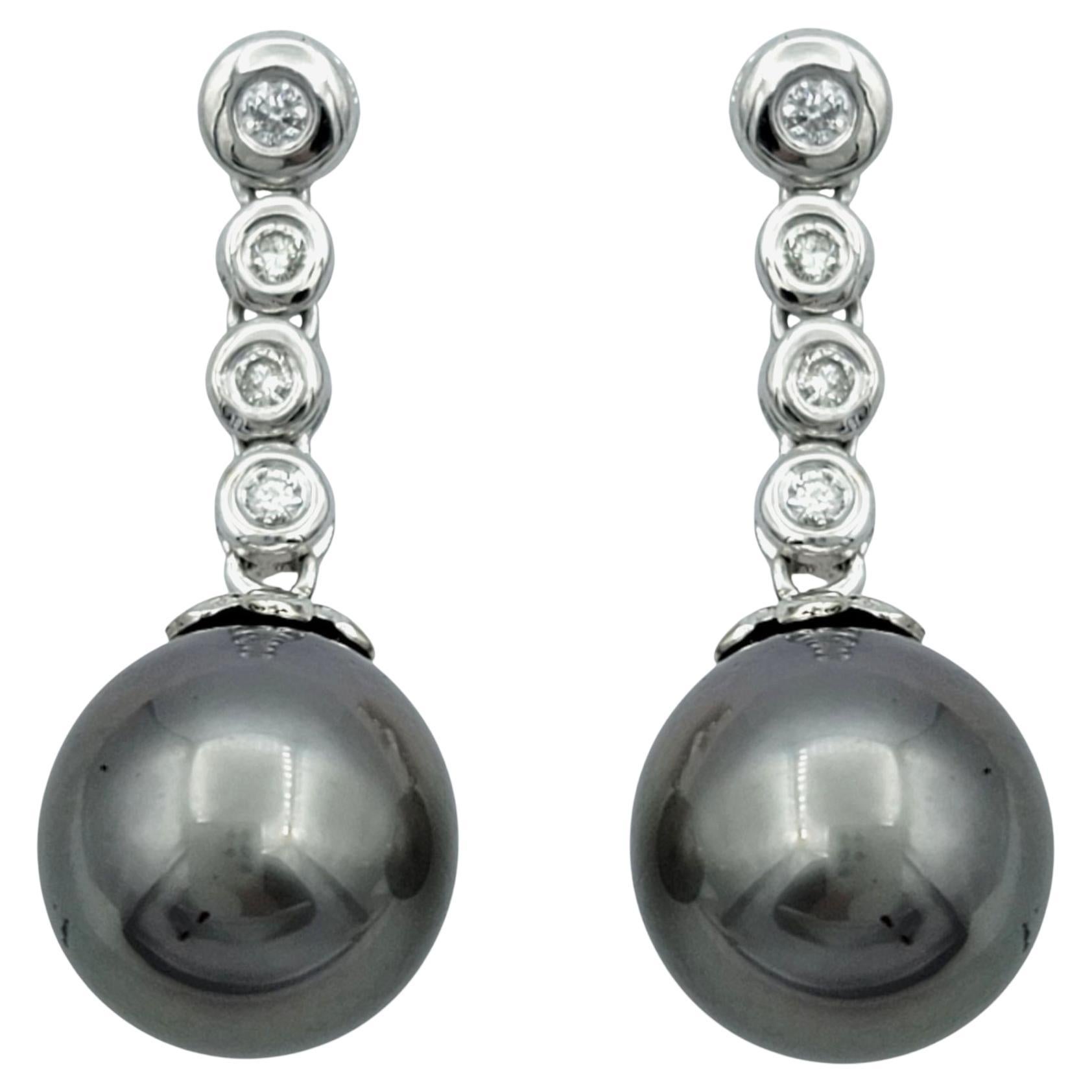 Bezel Set Diamond Drop Earrings with Black Pearls in 14 Karat White Gold