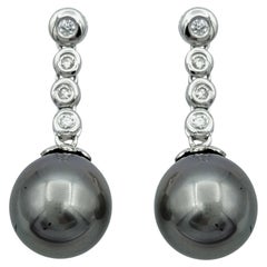 Bezel Set Diamond Drop Earrings with Black Pearls in 14 Karat White Gold