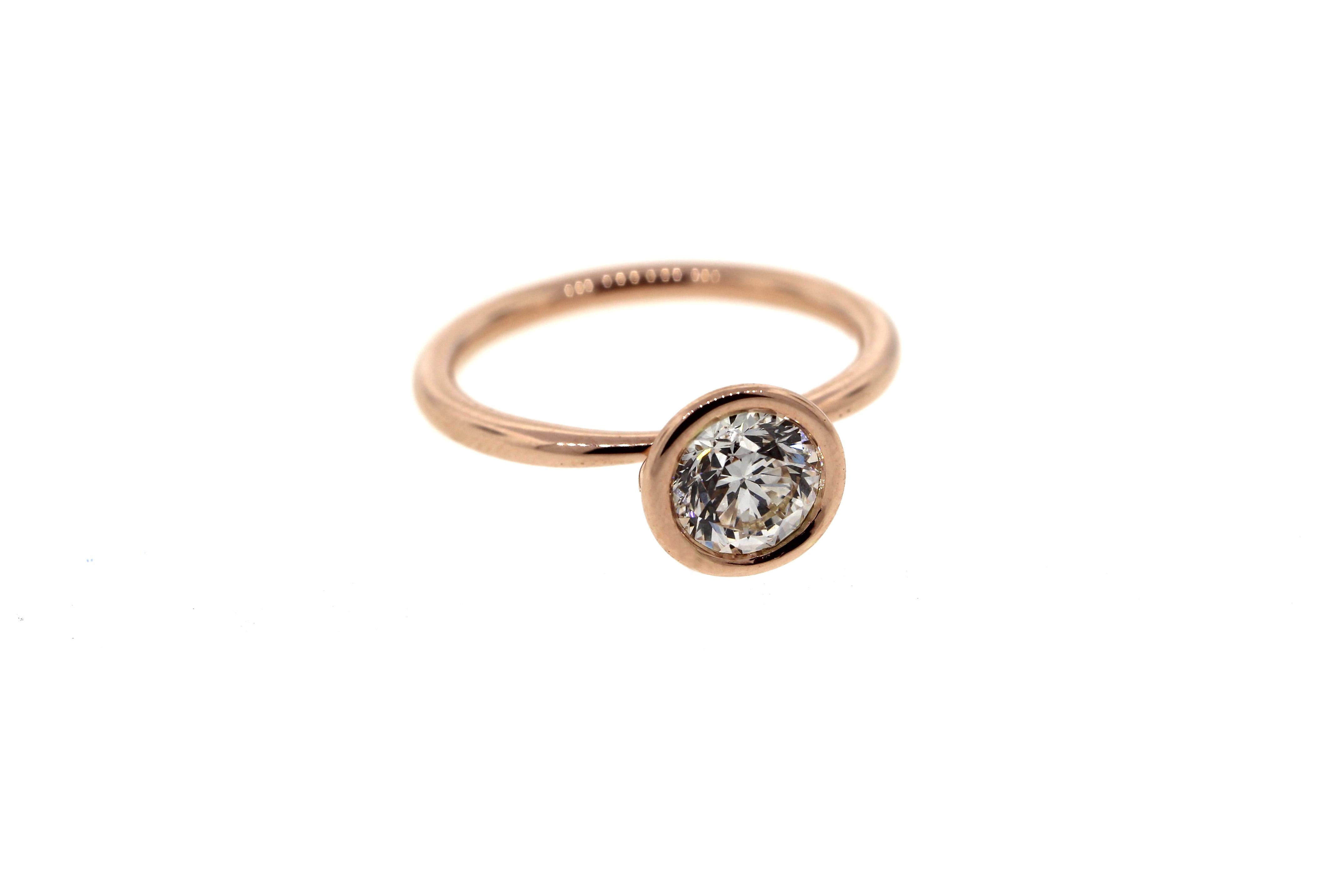 This beautiful bezel set diamond engagement ring is in rose gold and features a round brilliant cut GIA certified white diamond. 

Please note that each piece we make is customized to our client's specifications and the specifications for this ring