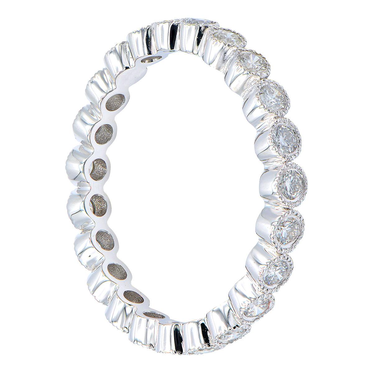 This beautiful eternity band has 23 round VS2, G color diamonds totaling 0.42ct that are set in 1.9 grams of 18 karat white gold. The diamonds go all the way around the band and are surrounded by beautiful goldwork attaching them together. This ring
