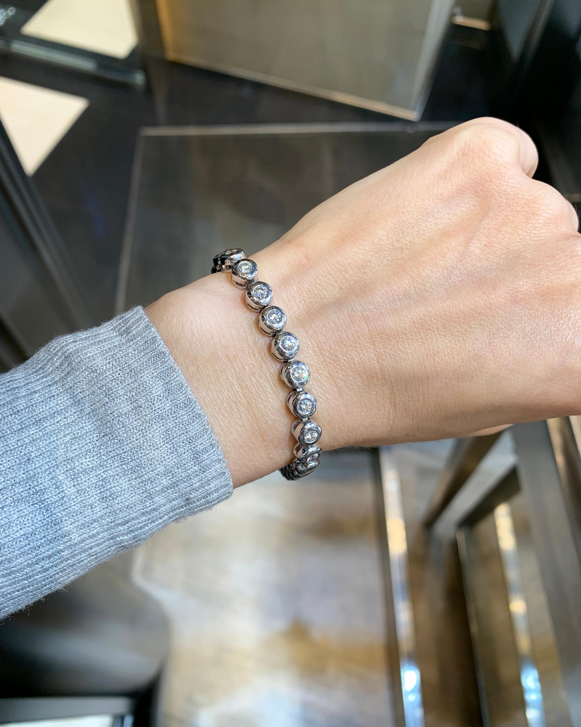 The tradition of the tennis bracelet, rooted in the diamond line bracelet of the 1920s, carries on with Spectra Fine Jewelry's Bezel-Set Diamond Platinum Tennis Bracelet. Crafted in 2019, this modern piece pays homage to minimalist luxury. Featuring