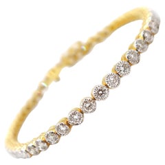 Pulsera de tenis con diamantes engastados en bisel en oro amarillo de 18 quilates con detalles milgrain