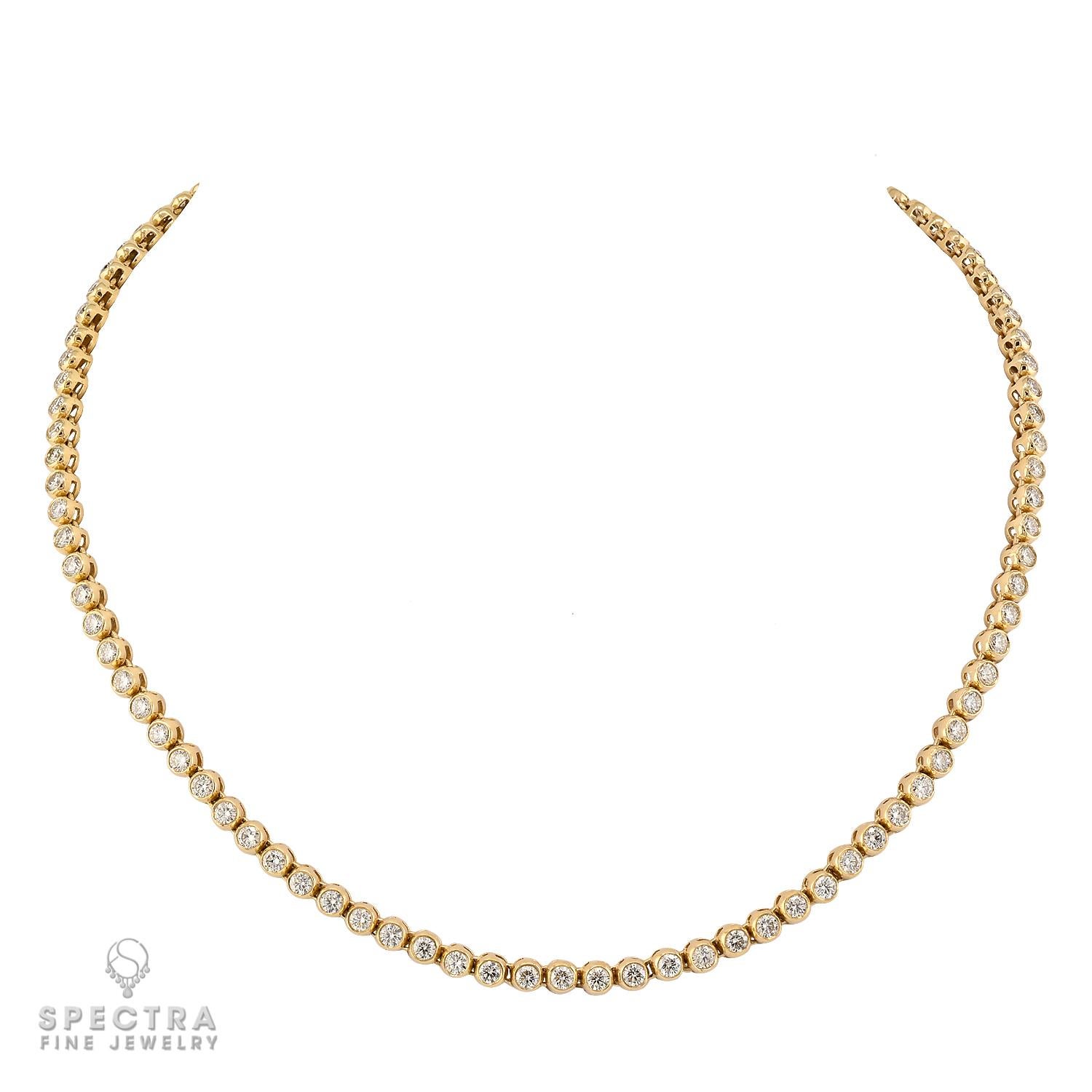 A timeless classic with a modern twist, this diamond tennis necklace captures the perfect balance of elegance and refinement. 
Crafted in rich 18k yellow gold, the piece features 98 round brilliant diamonds, each securely bezel set to enhance their