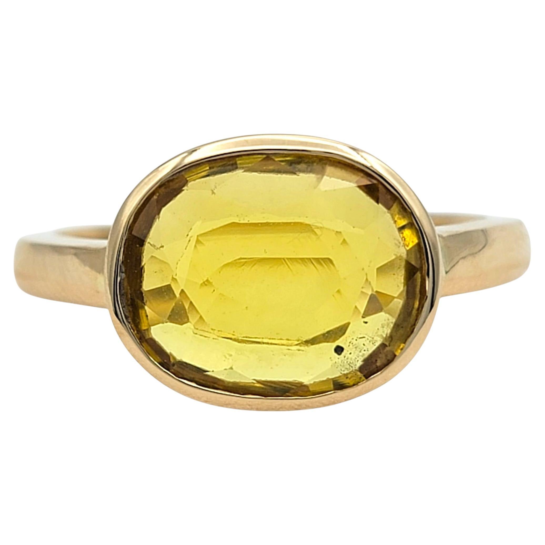 Bezel Set East West Oval Yellow Sapphire Solitaire Ring in 18 Karat Yellow Gold