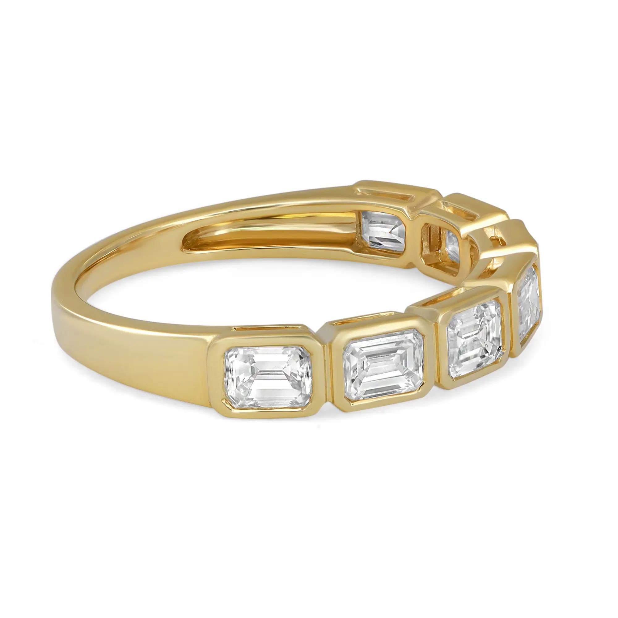 Celebrate everlasting love with this enchanting eternity band ring. Crafted in high polished 18K yellow gold. Showcasing 7 bright white scintillating bezel set emerald cut diamonds weighing 1.19 carats. Diamond quality: color G-H and clarity VS-SI.