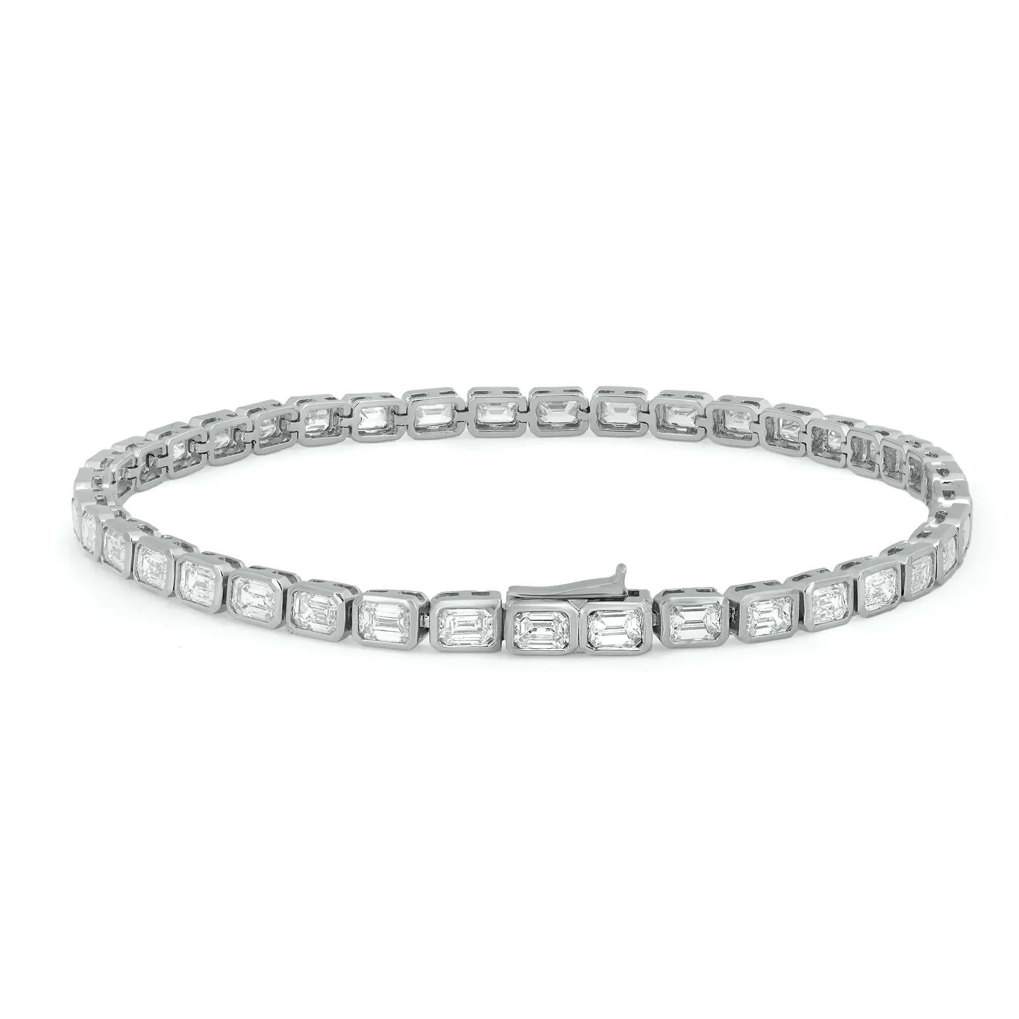 Classic yet elegant, this breathtaking tennis bracelet is crafted in 18K white gold with 39 bezel set dazzling emerald cut diamonds. Total diamond weight: 5.48 carats. The bright white diamonds are G-H color and VS-SI clarity. Bracelet length: 7