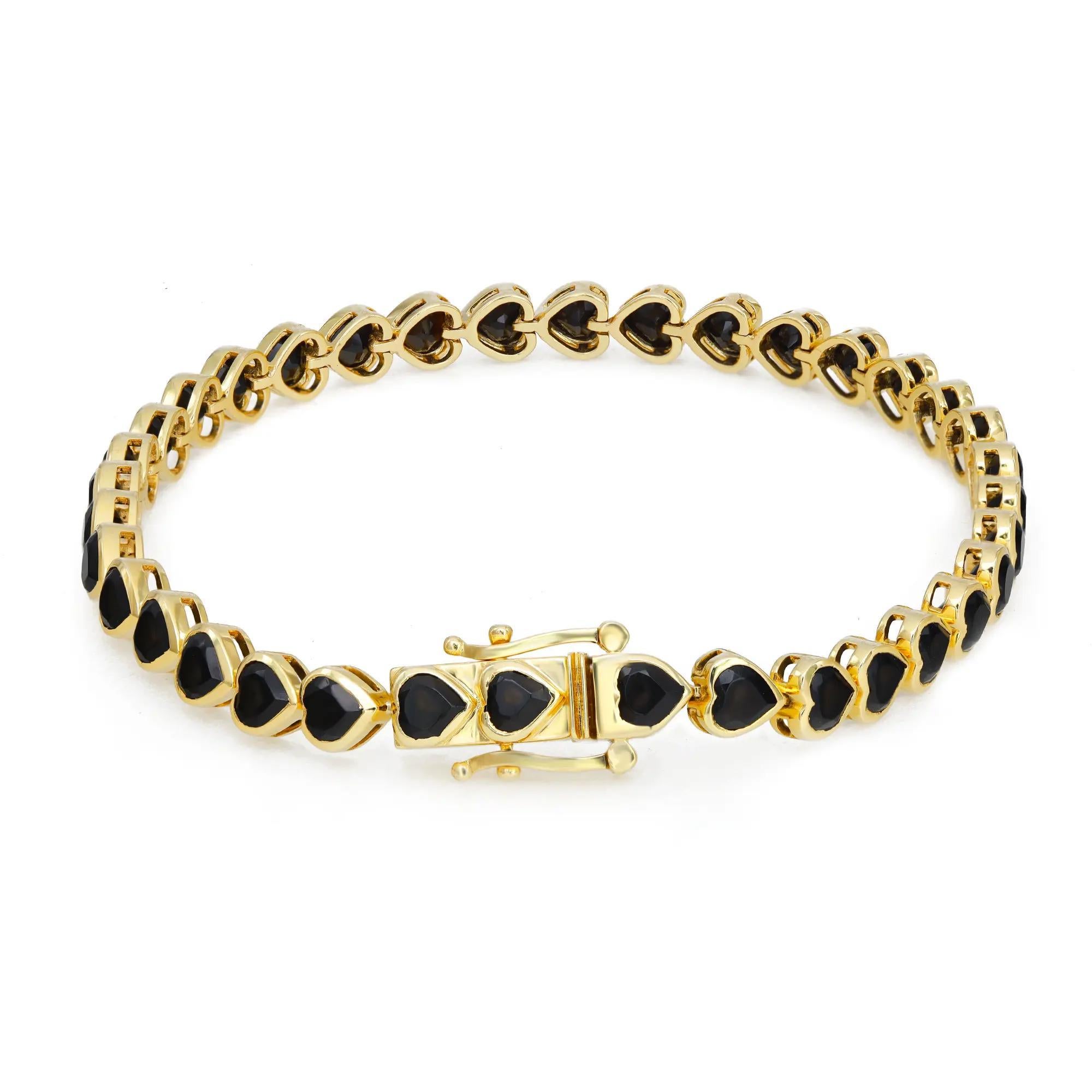 Fabulous and Chic, this Onyx tennis bracelet is a perfect addition to your wrist stack. Featuring, 36 heart shape black Onyx studded in a bezel setting in 14K yellow gold. Total Onyx weight: 7.90 carats. Secured with box clasp. Bracelet length: 7.5