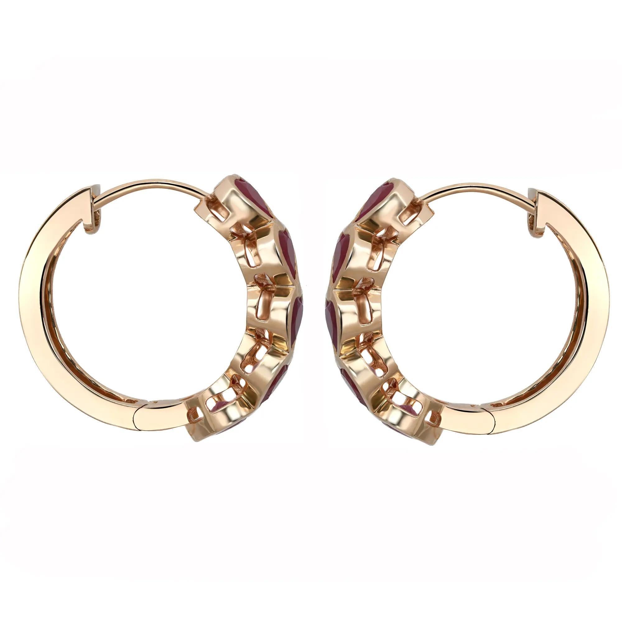 These glamorous huggie earrings feature five dazzling heart shape rubies encrusted halfway in bezel setting on each earring with heart shape cut outs on the other side. Crafted in lustrous 14K yellow gold. Total ruby weight: 2.89 carats. Earring