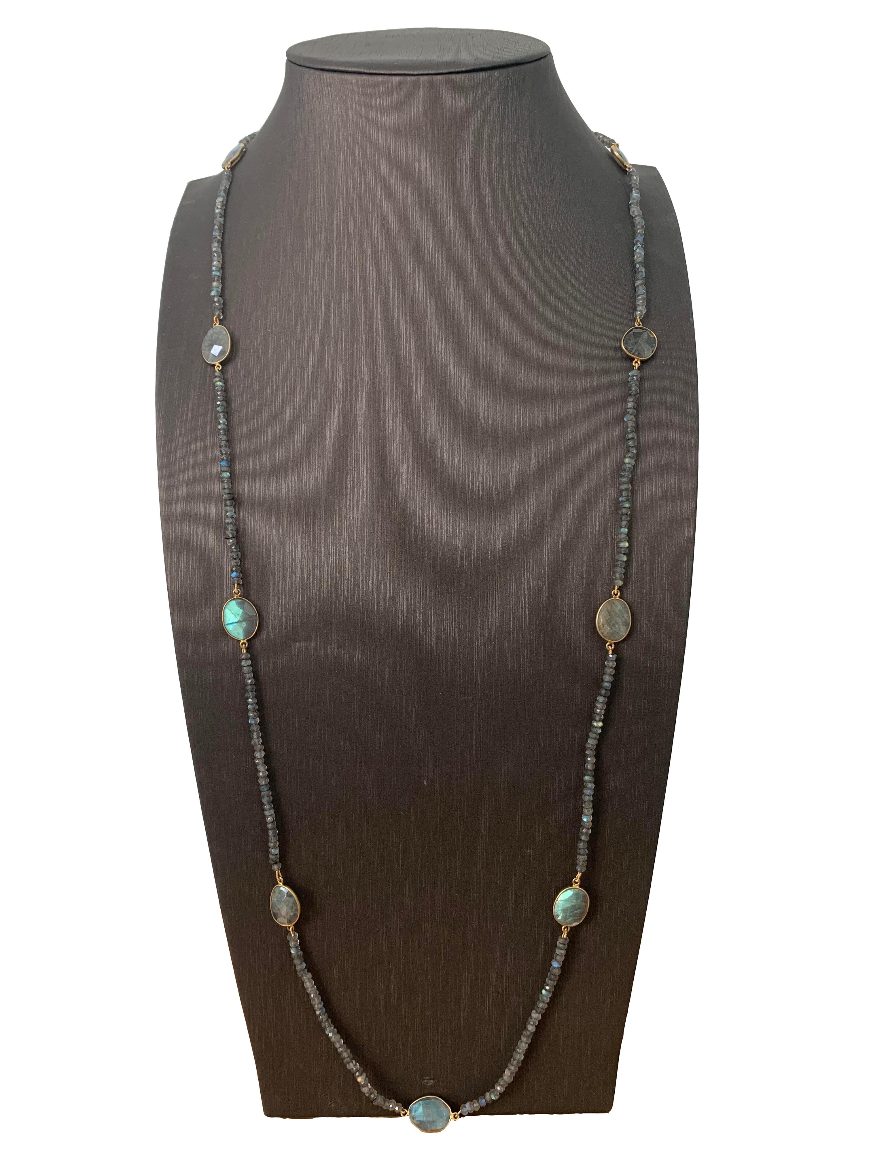 Beautiful bezel set rose cut Labradolite station necklace strung roundel Labradolite . 40 Inch Long. The setting and clasp are vermeil.

The entire necklace has beautiful rainbow iridescent, a unique feature of the stones. Can be worn long, double