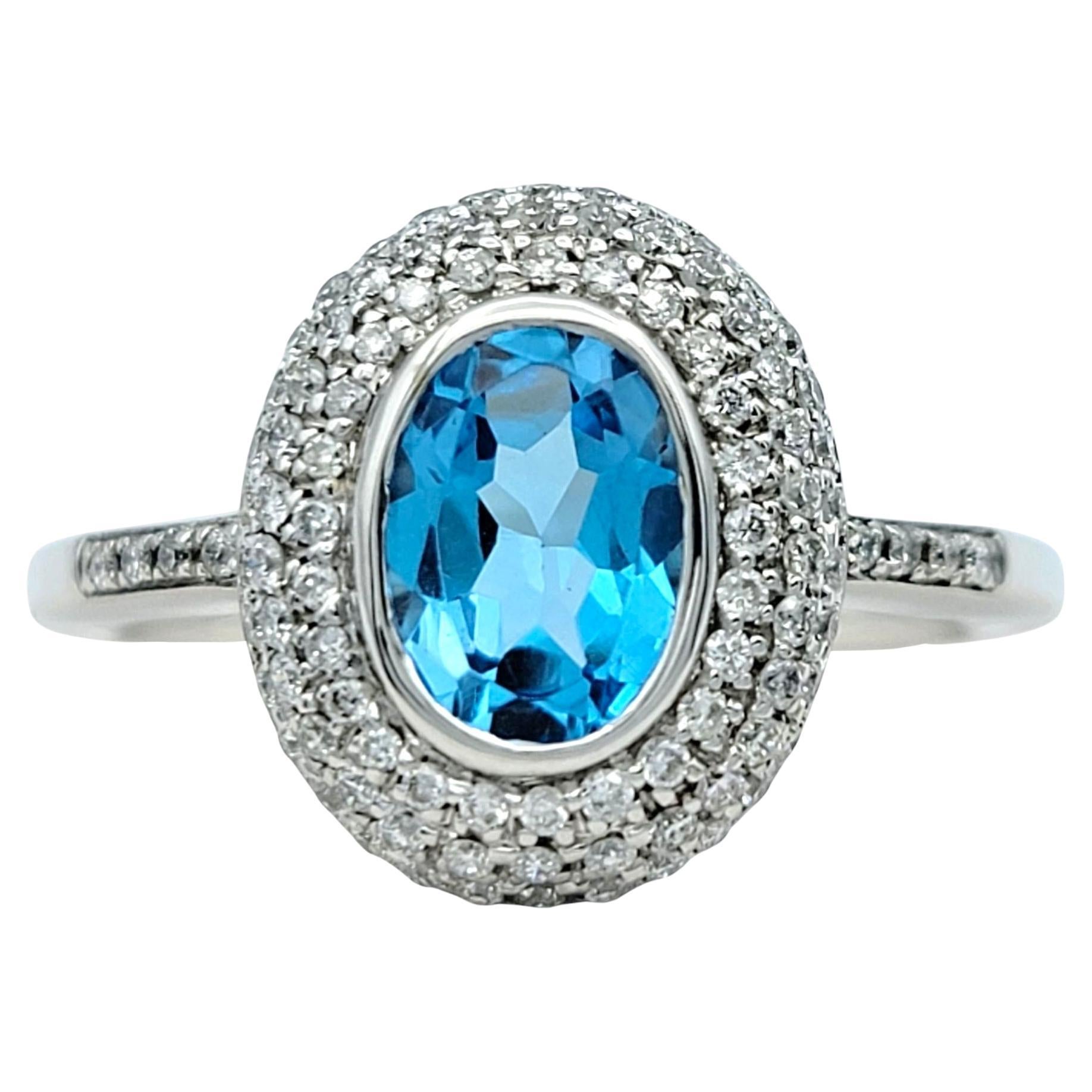 Bezel Set Oval Blue Topaz and Double Diamond Halo Ring in 14 Karat White Gold