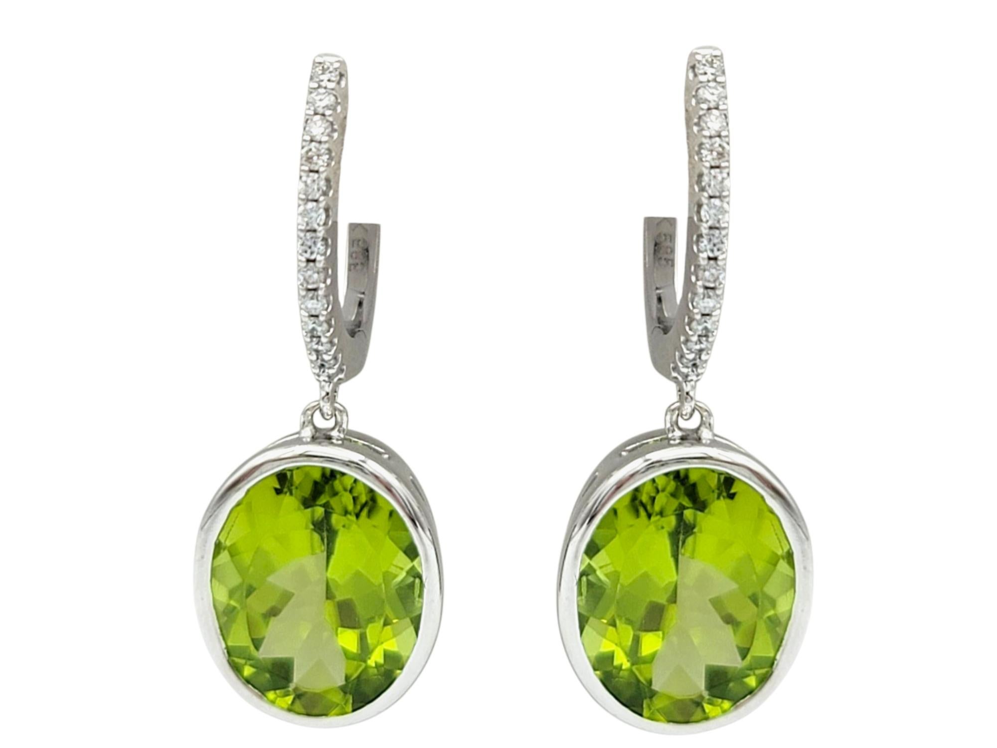 Bezel Set Oval Cut Peridot Dangle Earrings with Diamonds in 14 Karat White Gold In Good Condition For Sale In Scottsdale, AZ