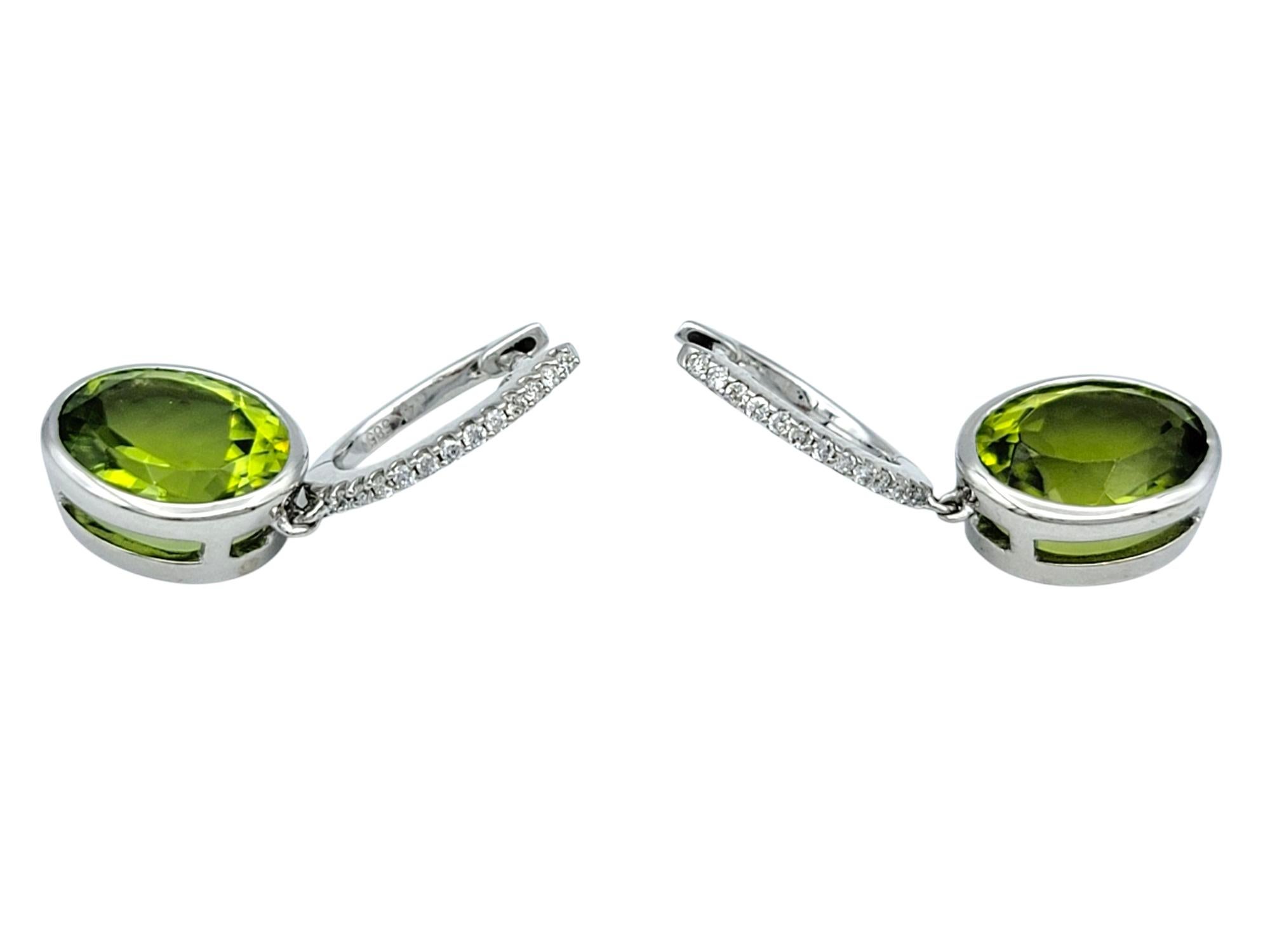 Women's Bezel Set Oval Cut Peridot Dangle Earrings with Diamonds in 14 Karat White Gold For Sale