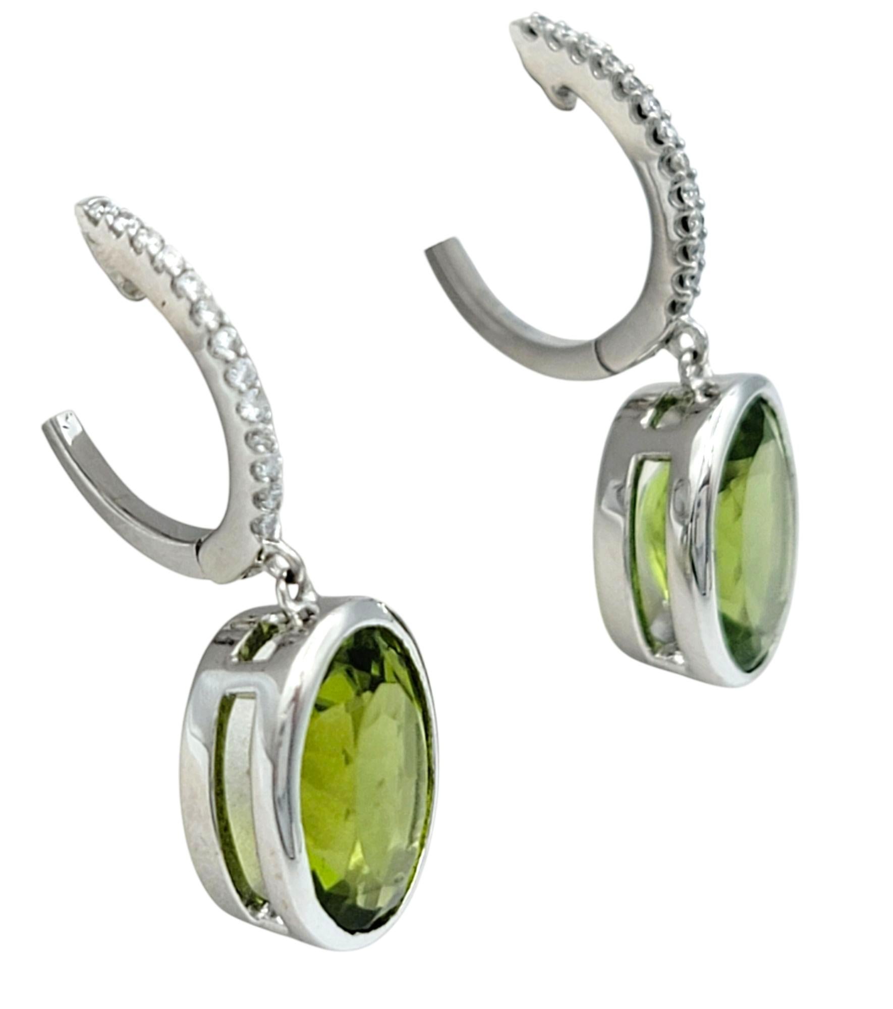 Bezel Set Oval Cut Peridot Dangle Earrings with Diamonds in 14 Karat White Gold For Sale 1