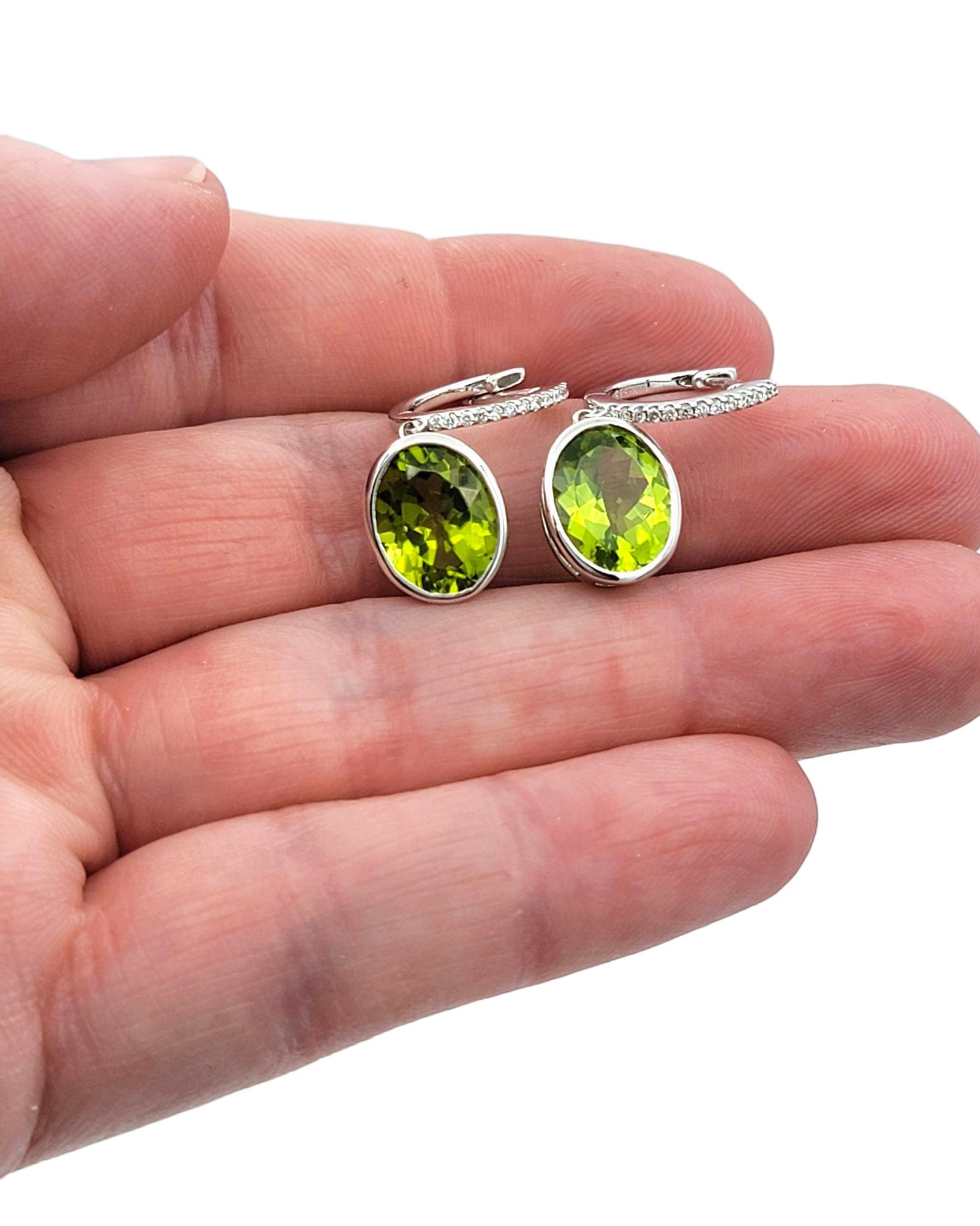 Bezel Set Oval Cut Peridot Dangle Earrings with Diamonds in 14 Karat White Gold For Sale 4