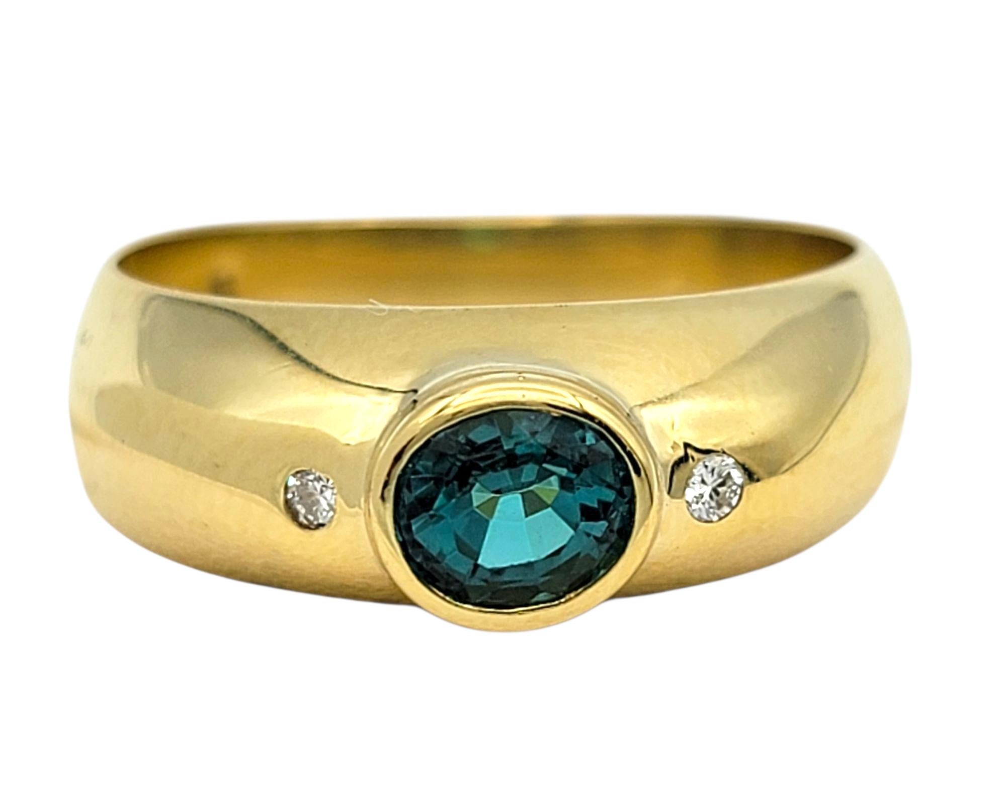 Ring Size: 8

This refined ring features a vivid oval-cut Paraiba tourmaline, glowing in a rich bluish green hue that is both exotic and captivating. Set in polished 18 karat yellow gold, the vibrant gemstone is the centerpiece of a sleek, modern