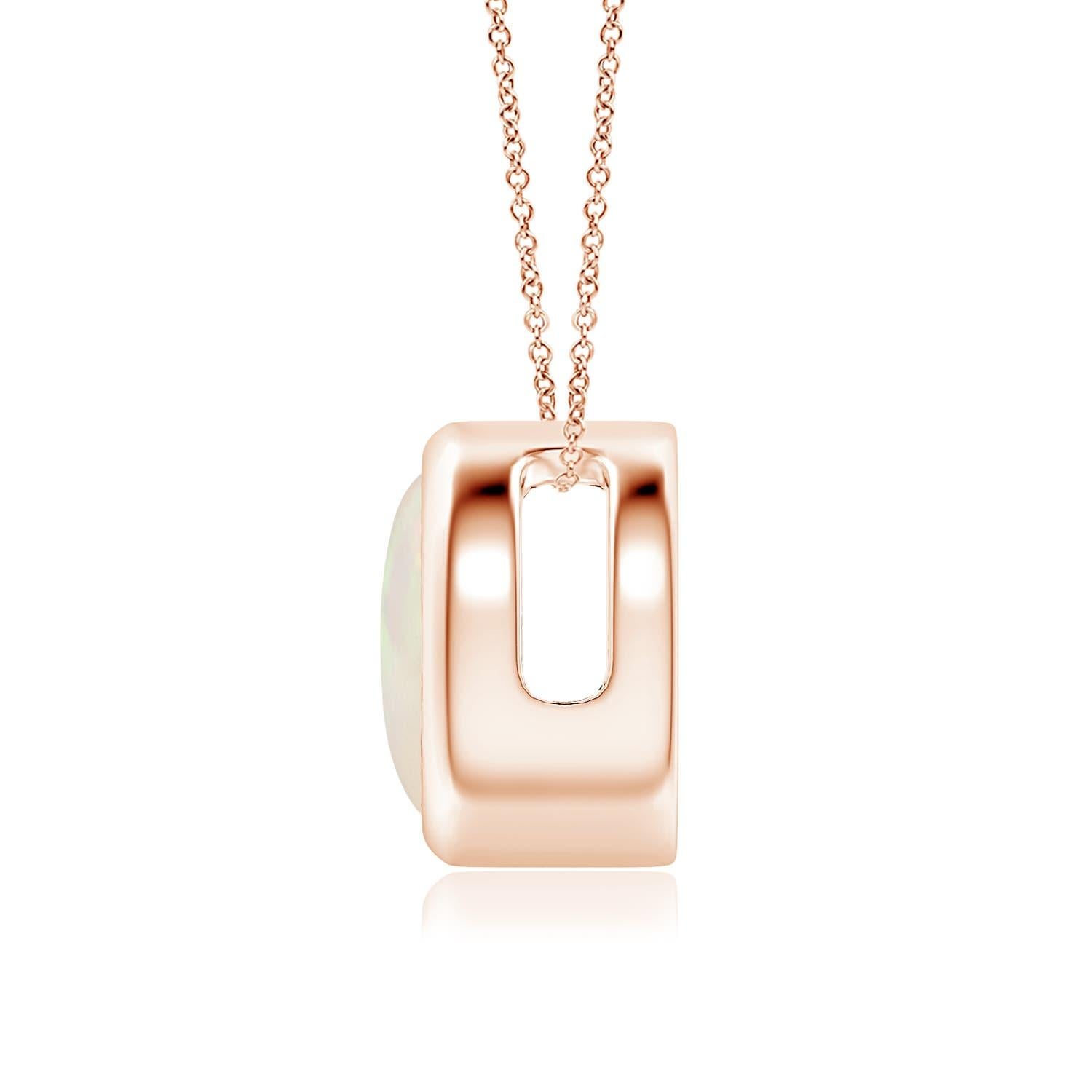 The mesmerizing round opal appears to be floating on the chain. It is secured in a 14k rose gold bezel setting. This simple yet alluring opal pendant is designed to make an elegant style statement with its stunning play of colors. Available in