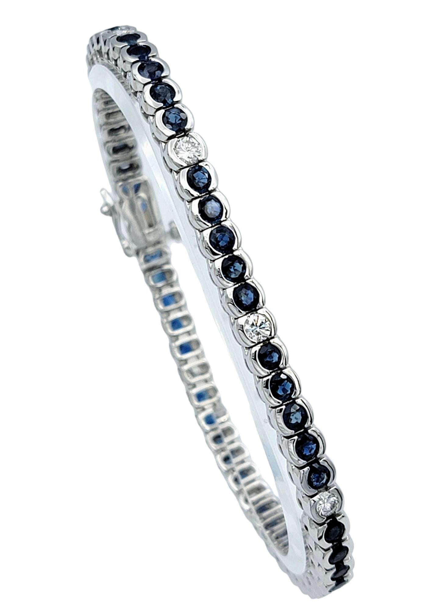 Introducing this exquisite sapphire and diamond tennis bracelet, elegantly crafted in 14 karat white gold. This stunning piece features an alternating series of radiant blue sapphires, each perfectly paired with a round brilliant diamond, all