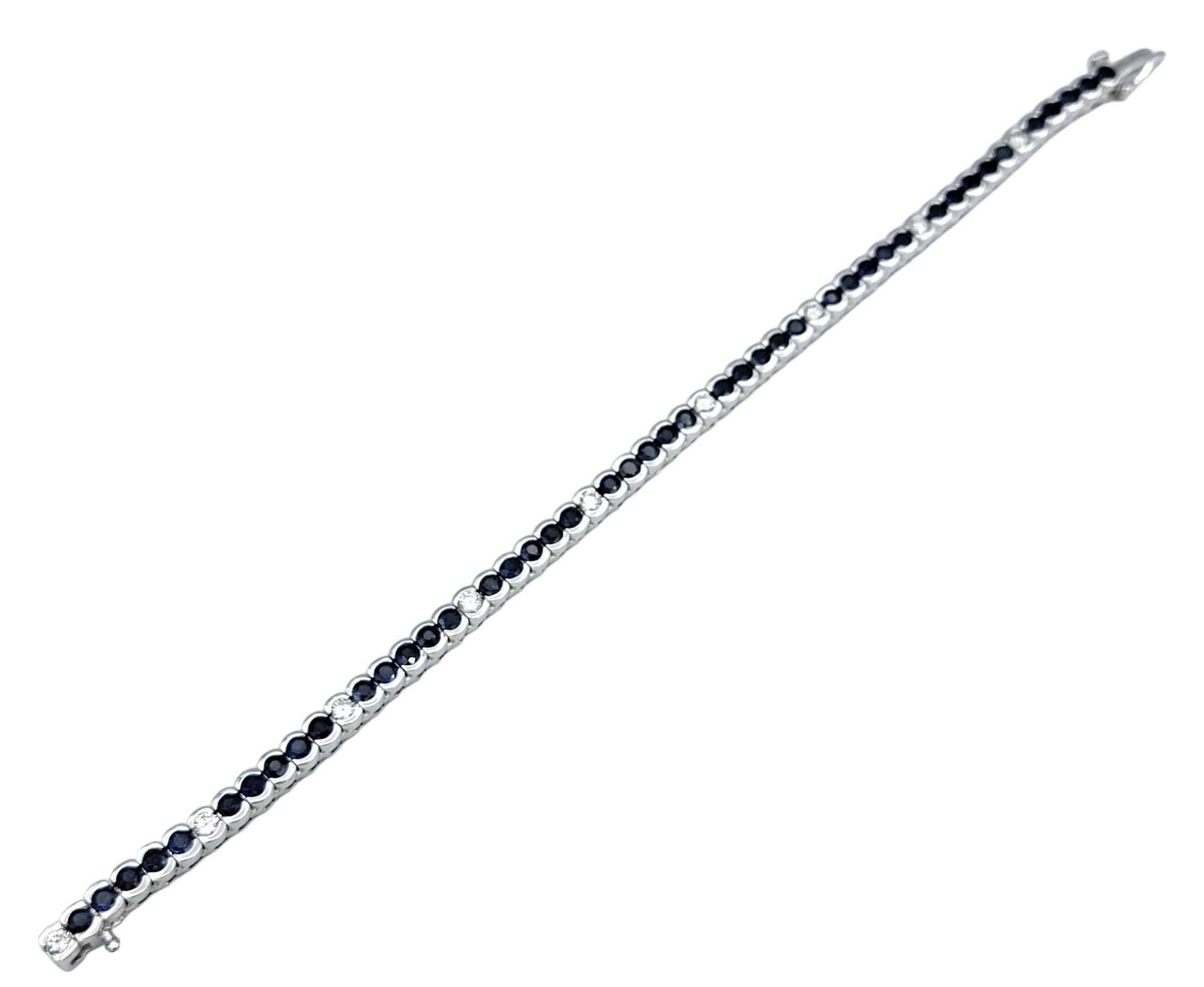 Contemporary Bezel Set Round Blue Sapphire & Diamond Tennis Bracelet in 14 Karat White Gold For Sale