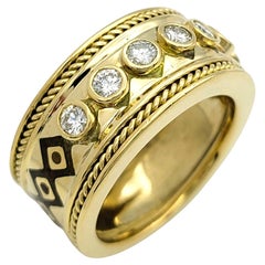 Ring mit geometrischem Motiv aus 18 Karat Gelbgold mit rundem Diamant in Lünette
