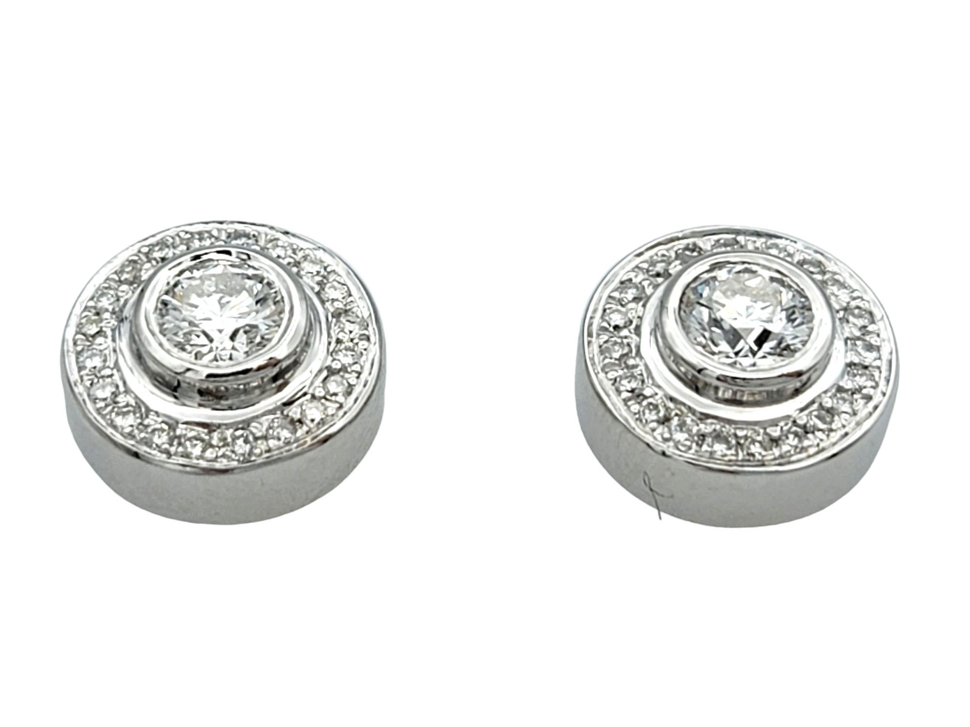 Contemporary Bezel Set Round Diamond Halo Design Stud Earrings in 14 Karat White Gold For Sale