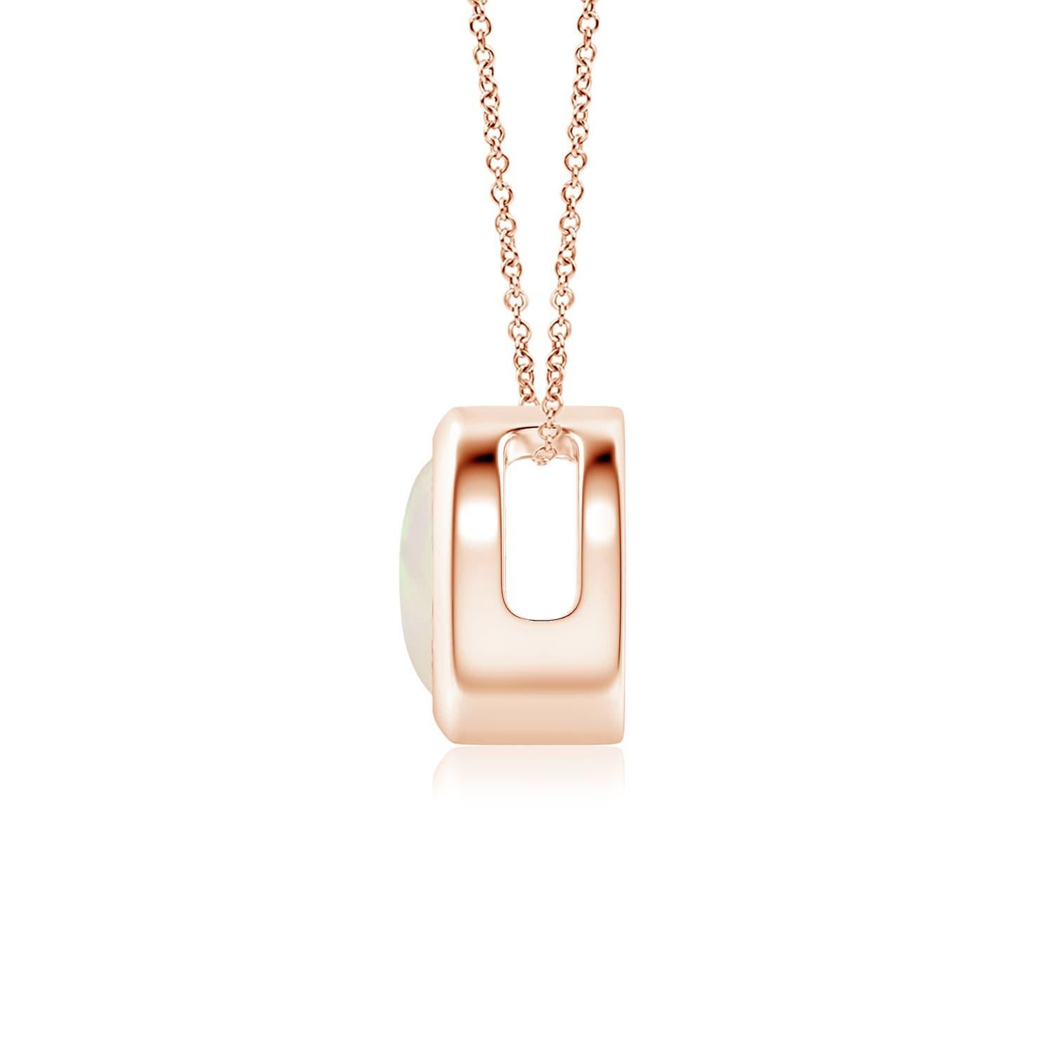 The mesmerizing round opal appears to be floating on the chain. It is secured in a 14k rose gold bezel setting. This simple yet alluring opal pendant is designed to make an elegant style statement with its stunning play of colors. Available in