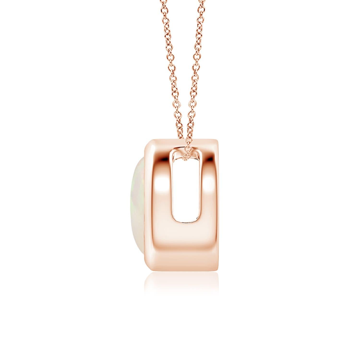 The mesmerizing round opal appears to be floating on the chain. It is secured in a 14k rose gold bezel setting. This simple yet alluring opal pendant is designed to make an elegant style statement with its stunning play of colors. Available in