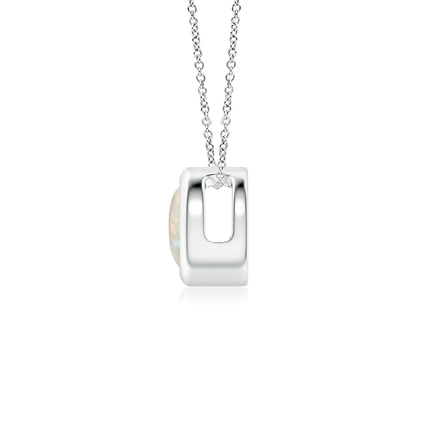 The mesmerizing round opal appears to be floating on the chain. It is secured in a 14k white gold bezel setting. This simple yet alluring opal pendant is designed to make an elegant style statement with its stunning play of colors. Available in