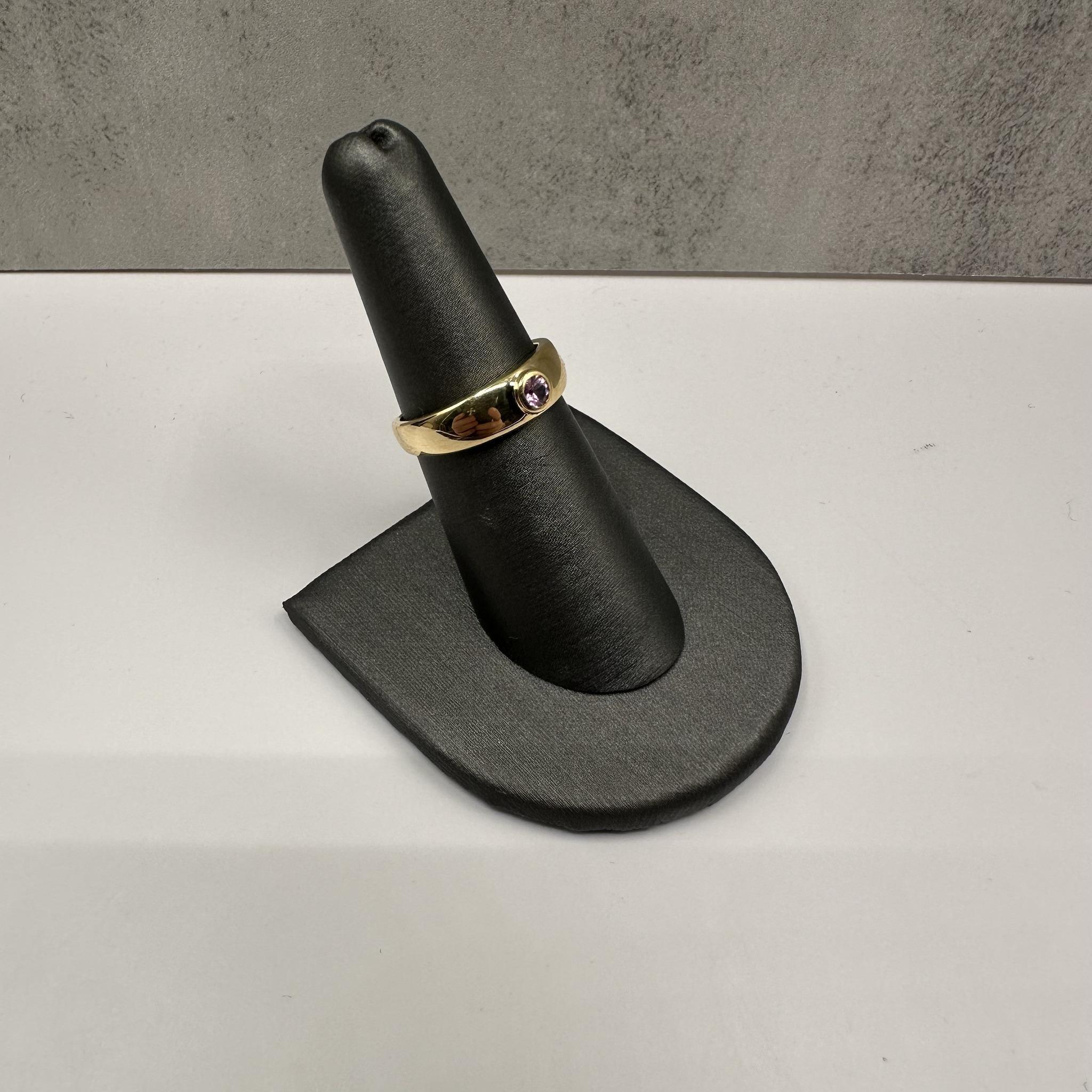 This charming Bezel Set Sapphire Dome Ring in 10kt Yellow Gold features 0.18 carat total weight (ctw) of round pink sapphires set in a sleek dome design. Weighing 2.1 grams and sized at 7, this ring offers a comfortable fit while providing a pop of