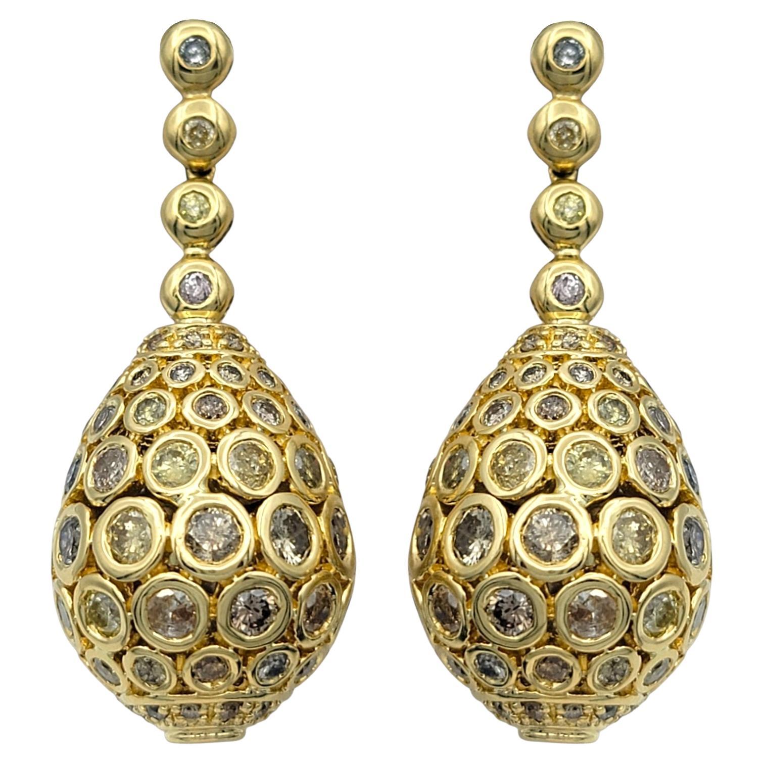 Ces boucles d'oreilles spectaculaires en diamant sont une expression audacieuse et luxueuse de la couleur et de la forme. Réalisé en or jaune 18 carats, ce modèle présente une silhouette en forme de goutte d'eau ornée d'un ensemble complexe de