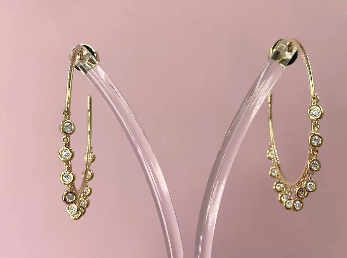 Diamond (0.65 total carat weight) bezel shaker dangle hoop earrings in 14k yellow gold. The earrings are designed and handmade locally in Los Angeles by Sage Designs L.A. using earth-mined and conflict free diamonds. The hoops are 1.5