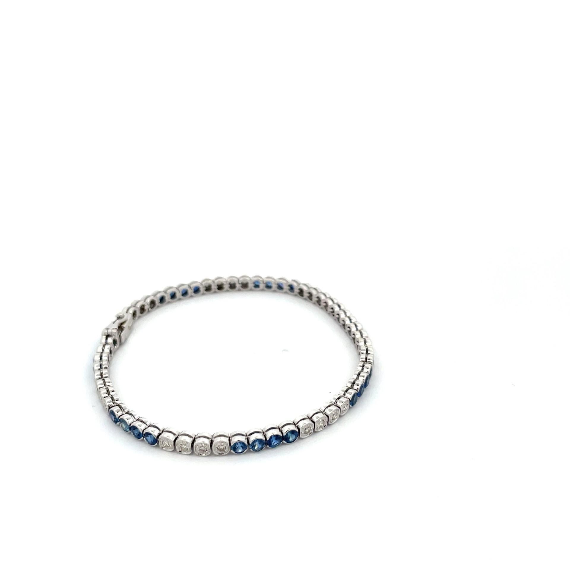An impressive bezel and tube 18 Kt white gold bracelet with natural blue sapphires and natural white diamond. It