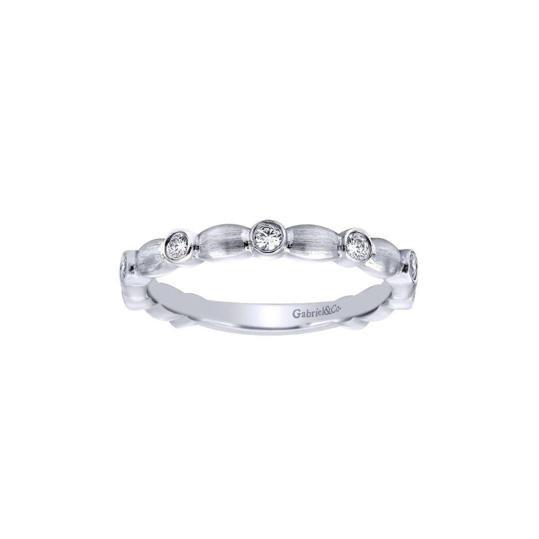 Elegant satin finish band with scallop design and bezel set diamonds in 14k white gold. Band contains 0.15 ctw of fine white round diamonds, H color, SI clarity. Band is suitable as a one of a kind wedding band, a fashion ring, anniversary ring, or